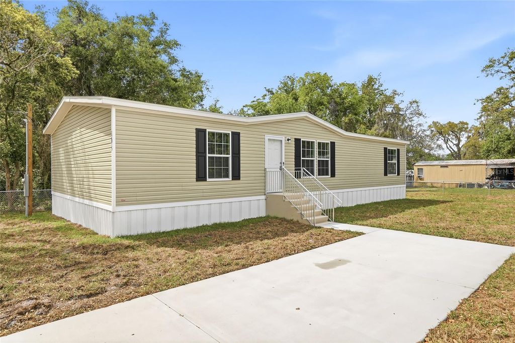 Photo of 12015 Westbay Avenue, New Port Richey, FL 34654 (MLS # TB8493271)