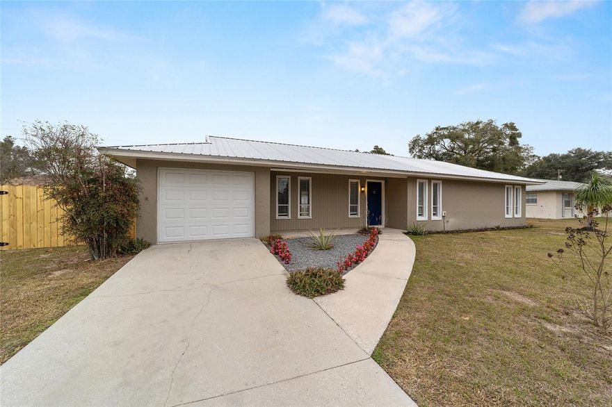 Bright, turnkey SE Ocala home — completely renovated with new roof, new luxury vinyl plank floors, new kitchen cabinets, granite counters, stainless appliances, plus new water heater, air conditioning, baths and lighting. move in ready