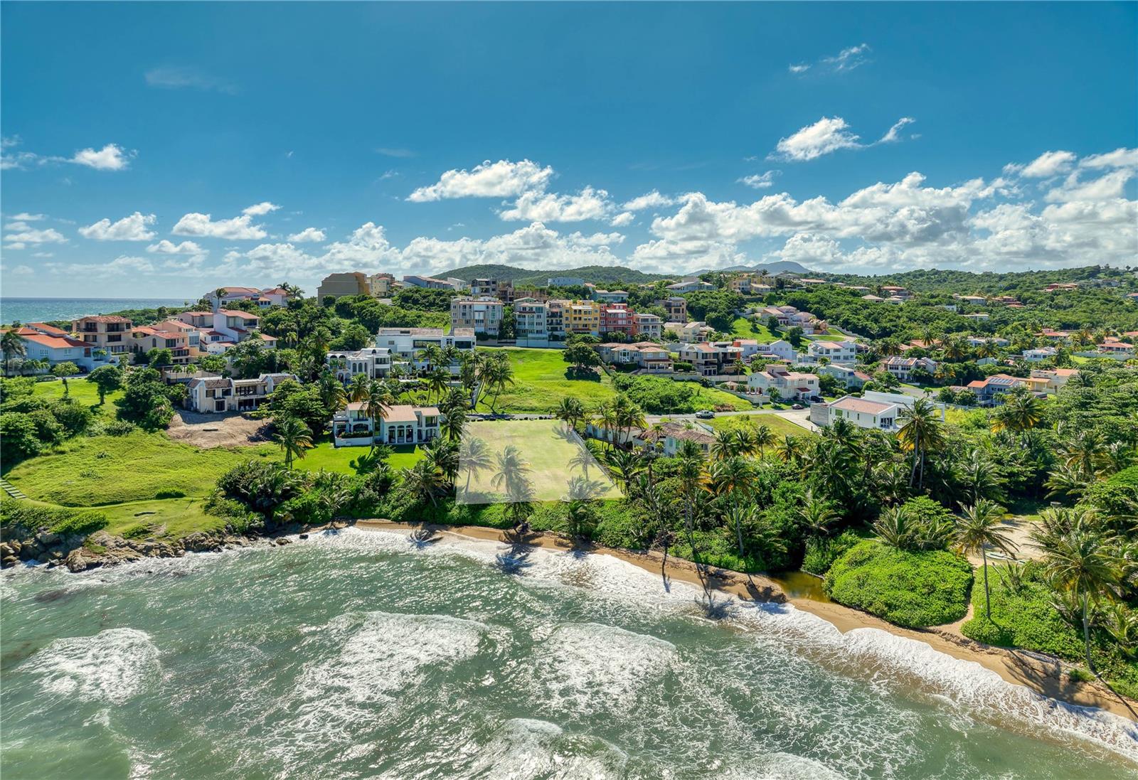 An extraordinary opportunity beckons for those seeking the epitome of beachfront luxury in Palmas del Mar. This rare-to-market gem invites you to savor the allure of living directly on the sand, offering unobstructed views of the Caribbean Sea and the myriad amenities that define the Palmas del Mar lifestyle. With a sprawling 1,457.12 sq. m canvas, this exclusive parcel of land sets the stage for a bespoke retreat by the sea. Positioned within a private cul-de-sac, this property provides not only exclusivity but also direct access to the pristine sandy beach, creating a lifestyle defined by the rhythmic embrace of the Caribbean waves. Seize the privilege of designing a residence of timeless beauty, where the dimensions of this property invite architectural innovation. Whether envisioning a Mediterranean-inspired haven or a sleek contemporary masterpiece, the possibilities are as limitless as the horizon. Wake up to breathtaking sunrise views over the sparkling waters and unwind in the evening as the sun sets in ultimate privacy. Immerse yourself in the refreshing waters, take leisurely walks along the shoreline, or indulge in your favorite watersports and activities. As part of Palmas del Mar's gated community, residents of 16 Surfside gain exclusive access to a host of amenities, including tropical beaches, multiple golf courses, tennis courts, restaurants, a private school, as well as the prestigious Yacht Club & Marina. Beyond the allure of the beach, the community's meticulously landscaped grounds and 24-hour security ensure a safe and serene environment for all residents. 16 Surfside is not just a property; it's an invitation to immerse yourself in the contemporary elegance of coastal living, where every day is a masterpiece of relaxation and indulgence.