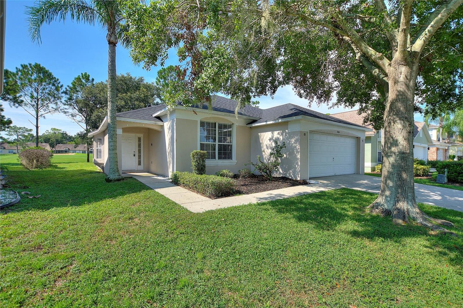 One or more photo(s) has been virtually staged. Welcome to 2761 Kokomo Loop, nestled in the Five Star Southern Dunes Golf and Country Club Community. This Grand Lagoon model, overlooking the golf course with stunning panoramic views, is perfect for short-term rentals, a winter retreat, or a full-time residence. Featuring a popular open-concept design, the bright and airy living, dining, and kitchen areas flow seamlessly to the covered lanai and private screened-in pool. With large sliding doors, tile flooring, and neutral décor, the space is both functional and welcoming—ideal for relaxing or entertaining in true Florida fashion. The layout includes two ensuite bedrooms, providing great flexibility and enhancing rental potential. The primary suite offers direct access to the lanai and pool, along with an additional pool entry from the ensuite bath, ensuring privacy, comfort, and convenience for everyone. Recent updates, including a new roof (2022), stainless steel appliances, carpeting, and fresh paint, add value and peace of mind. Located in the master-planned Southern Dunes Golf & Country Club, known for its championship golf course, residents and guests can enjoy 24-hour gated security, a clubhouse, floodlit driving ranges, tennis courts, a fitness center, a playground, and more. Just minutes from shopping, dining, and essentials, with easy access to Orlando, Tampa, area beaches, and major airports, this home offers the perfect blend of lifestyle and investment opportunities. Schedule your private appointment today!