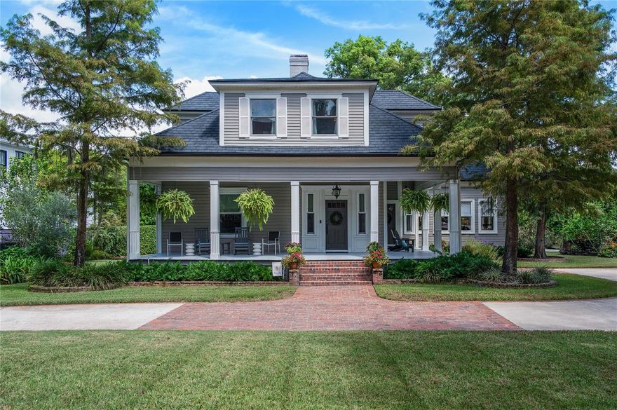 Nestled in the heart of downtown Winter Park, this beautifully maintained 1920s traditional residence captures the essence of Old Florida charm while offering the comfort of modern amenities. From the moment you arrive, the wraparound porch and circular drive create a welcoming first impression, setting the tone for the timeless character found throughout. Step inside to a gracious foyer accented by a cozy fireplace, leading into the spacious formal living room with its own gas fireplace and the elegant formal dining room. Gorgeous heart-of-pine floors run throughout the first floor, adding warmth and authenticity. The kitchen has been thoughtfully updated with top-of-the-line Thermador and Sub-Zero appliances, including a 72-bottle Sub-Zero wine tower and refrigerated drawers, making it as functional as it is beautiful. Open to the family room, complete with rich woodwork and a third gas fireplace, this space is ideal for gathering and entertaining. The primary suite is conveniently located on the first floor and features an updated ensuite bath. Upstairs, three additional bedrooms and two renovated baths provide comfortable accommodations for family and guests. A charming “sleeping room,” now used as a light-filled office, overlooks picturesque New England Avenue. Adding to the property’s appeal is a detached two-story guest house offering a full bedroom, full bath, sitting area, and kitchen—perfect for extended stays or as a private retreat. Outdoor living is equally inviting, with a back porch for grilling, a separate patio for lounging and mature landscaping that enhances the home’s curb appeal. Perfectly positioned on the same block as The Alfond Inn and just two short blocks from the renowned Park Avenue district, this home offers not just refined living, but a downtown walkable lifestyle that is truly unmatched. Park Avenue is the cultural heart of Winter Park—a tree-lined promenade alive with award-winning restaurants, boutique shopping, art galleries and historic landmarks. Residents enjoy a vibrant calendar of events, from the Winter Park Farmers’ Market and seasonal art festivals to beloved holiday parades and outdoor movies under the stars. Here, every day is an invitation to experience the best of Central Florida living—whether it’s sipping coffee at a charming café, strolling to or after dinner surrounded by beautiful ambience, or embracing the timeless traditions that make Winter Park so treasured.