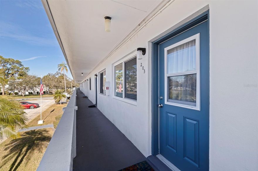 This one is just waiting for YOU:  NEW HVAC (2024), NEW Storm-Impact Windows (2025), Newer Hot Water Heater (2022) and Property Taxes are included in your HOA fees.  Safe and Close to so much, just pack your bags and stay for the winter or the whole year!  Enjoy easy, resort-style living in this well-maintained 55+ waterfront co-op community at Seminole Gardens. This partially furnished, second-floor one-bedroom, one-bath residence features a spacious living area, laminate flooring throughout, ceiling fans, and centrally controlled heat and air. The bedroom opens to a private enclosed lanai with peaceful canal views, perfect for morning coffee or evening relaxation while enjoying the dazzling array of birds and  other wildlife. The unit is located in a land-owned building with low maintenance fees. Co-op ownership offers exceptionally low property taxes, as taxes are included in the monthly maintenance fee. Recent updates include a building roof (2020), exterior paint (2025), and the already mentioned hot water heater (2022), high-end ground-unit HVAC (2024), and storm-impact windows (2025). Community amenities include a heated pool, hot tub, sauna, shuffleboard courts, library with billiards tables, two lakes connected by a canal, mature landscaping, and an active Community Center offering events and classes. Free community bus service runs five days a week. Ideally located steps from Seminole City Center for shopping, dining, and entertainment, close to restaurants, and just four miles from the beach. Located in a non-flood and non-evacuation zone. A perfect seasonal or full-time home offering low-maintenance Florida living. *Please note:  this is a non-smoking building.