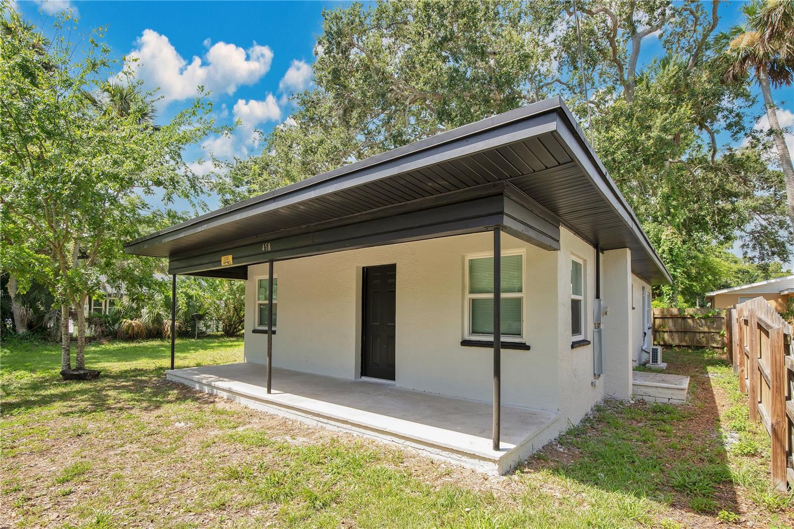 Fully renovated, move-in ready, and just seven minutes to the beach—this Daytona Beach gem checks every box: peace of mind, comfort, and location.A covered front porch sets the tone and welcomes you into a 2-bedroom, 2-bathroom home with a fresh, modern interior where everything is brand new. The layout is smart and functional, featuring a bright living room, a defined dining area, and a completely new kitchen with sleek stone countertops and all-new appliances. Both bedrooms are well-sized and split for privacy, each with access to a fully renovated bathroom. No detail was overlooked in the renovation. The home features a brand new roof, new windows throughout, three new mini split systems, a full electrical rewire, and a new electric panel. Inside, every surface has been refreshed—from the flooring and finishes to both fully redone bathrooms. Out back, the oversized yard offers plenty of space to enjoy under mature trees, with a detached shed for extra storage. Located just seven minutes from the beach and zoned for top-rated schools, this home puts you right in the heart of it all. Enjoy quick access to Daytona’s best shopping, dining, and entertainment, plus nearby parks, golf courses, and the iconic boardwalk. Whether you're heading out for a day on the sand or a night downtown, everything you need is just minutes from your front door. Whether you're searching for a primary home, a beach-close retreat, or a solid investment, this one delivers. Minutes from the ocean and convenient to shopping, dining, and everything Daytona has to offer—this is coastal Florida living, done right.