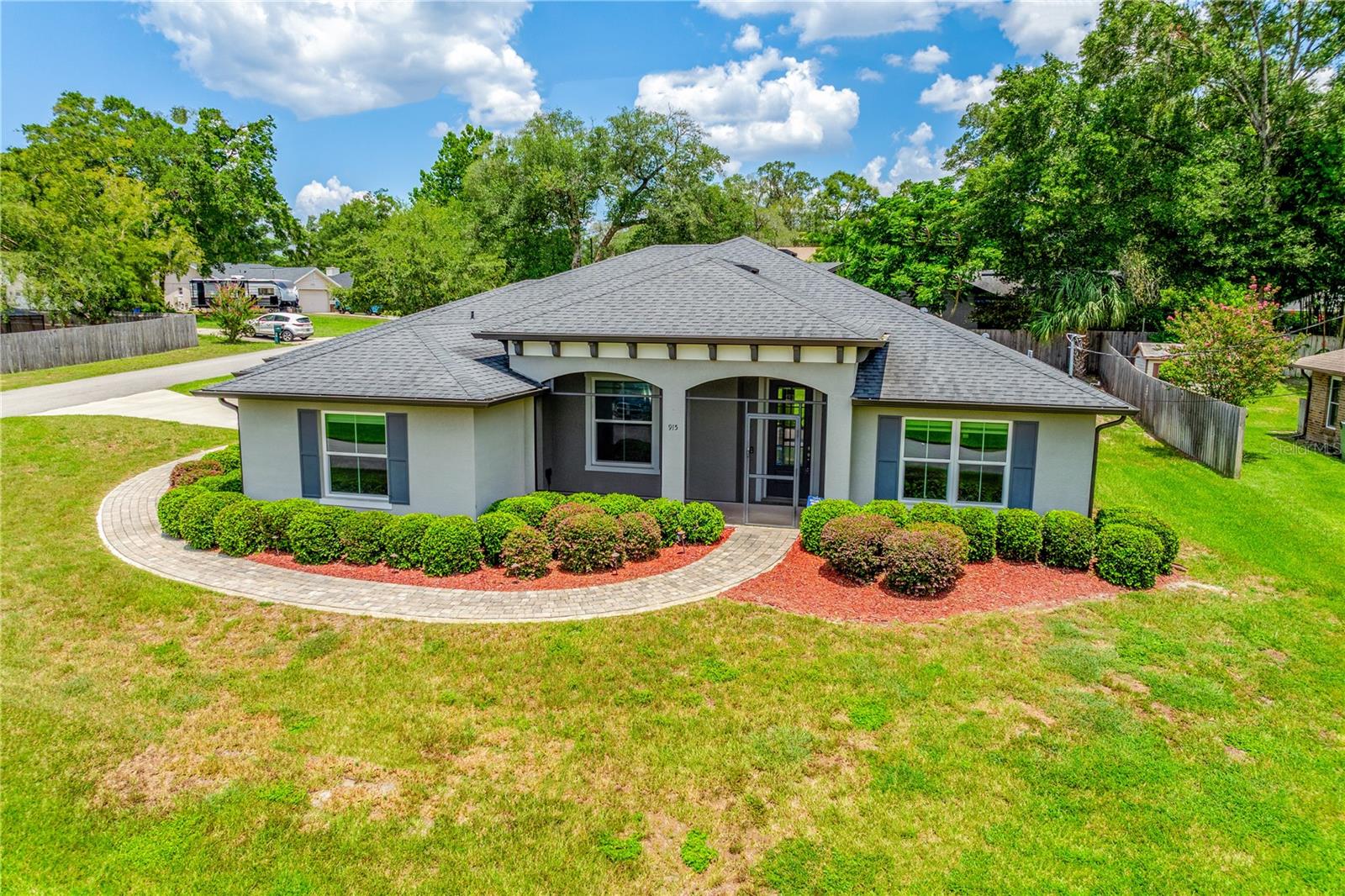 One or more photo(s) has been virtually staged. This property qualifies for a credit up to $5835 through the seller's preferred lender / Seller may consider buyer concessions if made in an offer ***Modern style meets everyday function in this meticulously maintained, 3BD/2BA + OFFICE single-story home located on a spacious .33 ACRE/CORNER LOT in Orange City with NO HOA, so no compromises! Built in 2017, this light-filled home is loaded with thoughtful UPGRADES and sleek finishes throughout. The CURB APPEAL draws you in, and the expansive driveway, OVERSIZED GARAGE, and ADDITIONAL PARKING PAD offer plenty of space for RVs, boats, or your favorite recreational toys! Stepping inside you will find high ceilings, insulated double-pane windows, and upgraded TILE FLOORING that flows through the main living areas. The OPEN CONCEPT layout is perfect for entertaining, anchored by a stunning chef’s kitchen complete with shaker-style cabinetry, contrasting center island with breakfast bar, must have STAINLESS STEEL APPLIANCES, stone countertops, and a nice WALK-IN PANTRY for ample storage. The kitchen is open to the living and dining areas and flooded with NATURAL LIGHT thanks to TRIPLE SLIDING GLASS DOORS that lead to a COVERED LANAI and FENCED BACKYARD. The SPLIT BEDROOM layout provides privacy to the PRIMARY SUITE, featuring a CUSTOM WALK-IN CLOSET, a second reach-in closet, and a stylish en suite bath. Two additional bedrooms and a second full bath are tucked away on the opposite side of the home. A dedicated home OFFICE with CUSTOM BUILT-INS and chic BARN DOORS offers a quiet and inspiring place to work or create. You will also love the oversized laundry room with built-in storage, a folding counter, and a bright window that keeps things feeling airy. Extras include: CUSTOM SHADES THROUGHOUT, a dump sink and included fridge in the garage, and everything in excellent condition – inside and out! Located close to US 17 and just minutes from I-4, this home is central to both Orlando and the beaches, with shopping, dining, and recreation all within easy reach. This is the kind of home that is hard to find—modern, MOVE-IN READY, and full of space and style. Call today to schedule a tour!