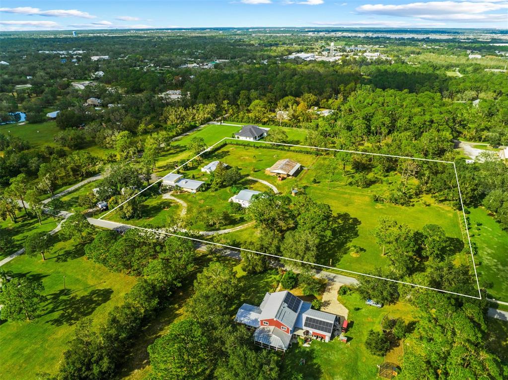 Tranquil Nature-Lovers 5-Acre (Approximately) Piece of Paradise Hobby Farm, Property Features: 2 Houses Main House: 3 Bedroom w/ 2 Baths, Stone Fireplace. 2nd Floor Separate Entrance 1 Bedroom Apartment w/ 1 Bath. 2nd House New Roof 2023 Features 2 Bedrooms w/ 1 Bath, Fireplace. Barn Features New Roof w/ 10 Horse Stalls & 4 Tack Rooms, Storage Loft, Bathroom / Shower Facilities. Separate Building Art Studio / Workshop w/ 2 Car Carport. Excellent Rental / Investment Potential. 3 Pastures. Front Pasture is Irrigated. Amazing Redevelopment Opportunity.