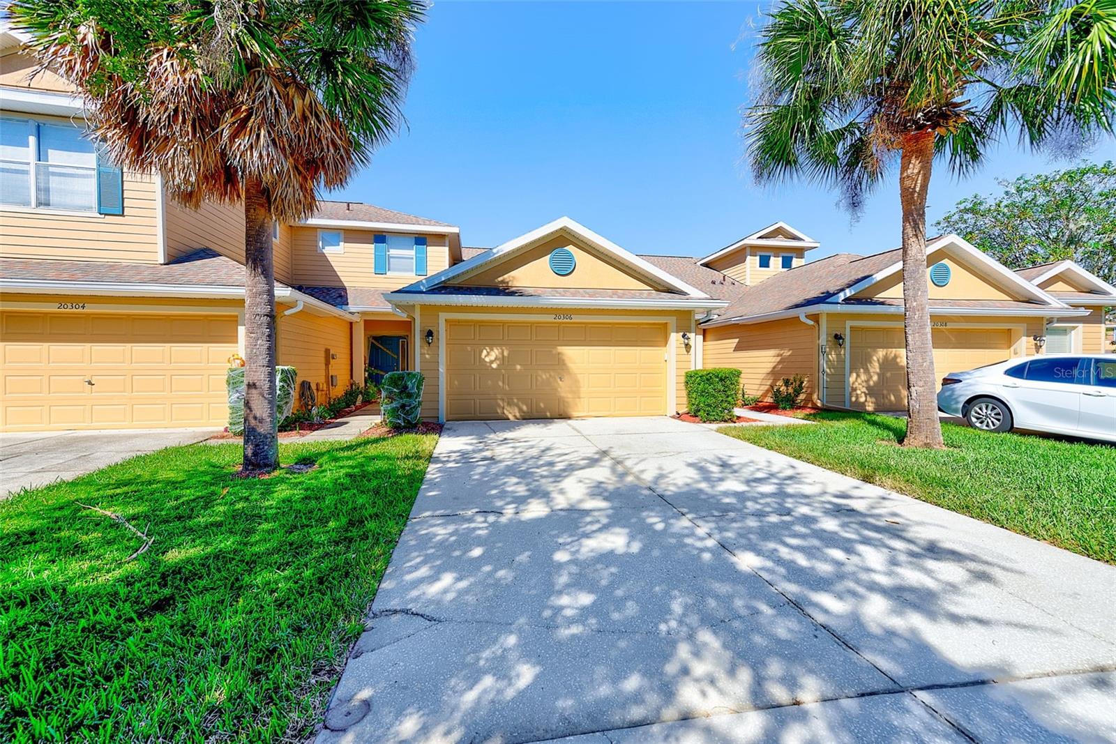ARE YOU LOOKING FOR THE IDEAL NEW TAMPA LOCATION WITH CONVENIENCE TO I 75, THE TOP RATED SCHOOLS, FANTASTIC SHOPPING AT THE WIREGRASS MALL & TAMPA PREMIUM OUTLETS AS WELL AS COSTCO, USF, MOFFIT CANCER CENTER, ADVENT HEALTH, PUBLIX, NUMEROUS RESTAURANTS AND STONE'S THROW TO THE GROVE THEN THIS WOULD CHECK THOSE BOXES! THIS TOWNHOME IS READY AND WAITING FOR YOUR ARTISTIC TOUCHES! A SPACIOUS 3 BEDROOM, 2 AND 1/2 BATH UNIT BOASTING 1,455 SF WITH A 2 CAR GARAGE AWAITS! THIS SPLIT FLOOR PLAN IS IDEAL WITH THE MASTER SUITE ON THE LOWER LEVEL AFFORDING THE MOST PRIVACY AND THE OTHER 2 BEDROOMS & FULL BATH ARE ENJOYED ON THE UPPER LEVEL! FEATURES INCLUDE A SEPARATE INDOOR LAUNDRY ROOM, KITCHEN HAS ALL APPLIANCES AND NICE CLOSET PANTRY. THE LOWER LEVEL HAS A GUEST HALF BATH AND A VERY WELCOMING FOYER! NICE SIZED GREAT ROOM ALLOWS THE VERSATILITY OF ANY SIZE FURNITURE TO ACCOMMODATE A LIVING AND DINING ROOM COMBO WITH THE KITCHEN OVERLOOKING THIS SPACE WITH A USEFUL BREAKFAST BAR FOR HURRIED MEALS! THE COMMUNITY OF LIVE OAK PRESERVE THE VILLAGES OFFERS AN AMAZING ARRAY OF RESORT STYLE AMMENITIES INCLUDING THE GATED ENTRY, COMMUNITY POOL/SPA WITH A SPLASH ZONE, NICE CLUBHOUSE, FITNESS CENTER, TENNIS OR VOLLEYBALL COURTS AND FANTASTIC PLAYGROUNDS AND WALKING TRAILS THROUGHOUT FOR MAXIMUM OUTDOOR LIVING! ONE OF THE BEST VALUES IN ALL OF THE NEW TAMPA AREA WITH MODEST HOA FEES OF $350/MONTHLY AND SMALL CDD FEES OF $820/ANNUALLY THIS HOME IS AFFORDABLE!