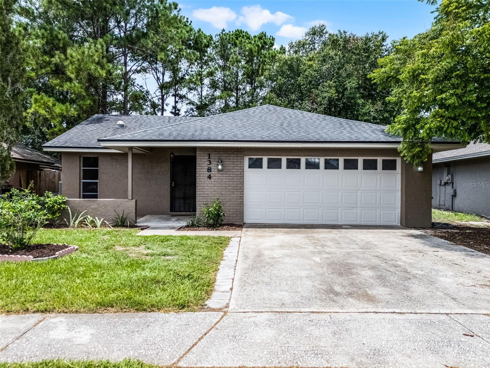 One or more photo(s) has been virtually staged. Welcome to this beautifully maintained 3-bedroom, 2-bathroom home in Winter Springs' Sunrise community that blends comfort, style, and functionality. Fresh exterior paint, two-car garage, and newer roof (2018) greet you upon approach. Step inside to discover a bright, open living space highlighted by vaulted ceilings and sleek laminate flooring throughout. The freshly painted interior gives the home a clean, modern feel, ready for you to move right in. A large living space is located right inside the front door, which then transitions into a secondary living space or a great dining room - whatever you may choose. The heart of the home is the kitchen, which opens to the living spaces, featuring solid-wood cabinets, stainless steel appliances, and ample counter space—perfect for everyday cooking and entertaining. Three bedrooms offer generous space, natural light, and good size closets. The primary suite features a private bathroom with a single sink vanity and large, tile shower/tub combo while the secondary bathroom also boasts a single-sink vanity and shower/tub combo. A covered patio or Florida room is located off the living spaces and opens to an open patio out back. The partially fenced backyard offers privacy and room to relax, garden, or host gatherings. This home checks all the boxes—don’t miss the opportunity to make it yours!