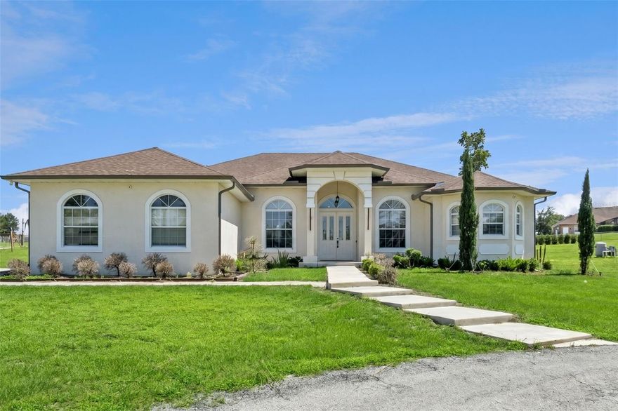 One or more photo(s) has been virtually staged. Rare opportunity in Winter Garden's coveted Lake Avalon: a fully fenced and gated 5-acre mini-ranch in the Valley View enclave, where genuine Lake Avalon water and conservation views meet true rural freedom — bring your horses, livestock, or recreational vehicles — just minutes from Hamlin Town Center, Walt Disney World, and SR-429.
Spanning nearly 3,800 SF, this thoughtfully expanded 5BR/4BA estate includes a substantial permitted addition that created an ideal wing for multi-generational living or large-scale entertaining. At its center is a redesigned custom kitchen with imported Italian cabinetry, waterfall-edge countertops, premium Thermador appliances, and a built-in Dacor smart refrigerator. A separate enclosed prep kitchen with additional appliances and laundry hookups adds rare day-to-day functionality.
The layout offers dual primary suites, formal and casual living spaces, oversized tile flooring, modern LED lighting, and remodeled baths — openness and privacy as you need them. Major systems deliver long-term peace of mind: a NEW ROOF (2022) NEW HVAC (2022), an 80-gallon commercial water heater (2022), a whole-home water softener, and a 24KW whole-house standby generator with transfer switch for full backup power.
Zoning flexibility, sunset and lake views, and no cookie-cutter HOA rules — one of the last true large-lot enclaves this close to Winter Garden's growth corridor. Schedule your private tour today.