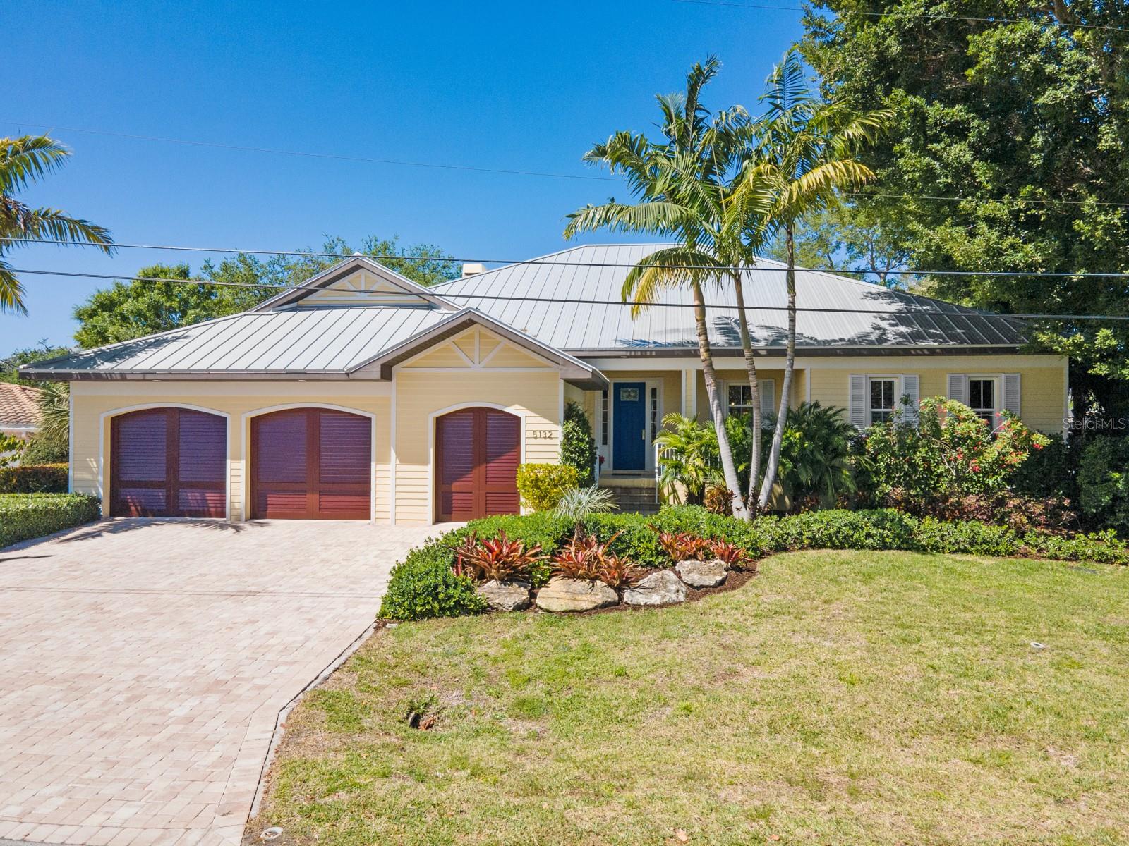 Combining stylish residential living with the allure of a world-renowned beach destination five minutes away, this beautiful Siesta Key property is perfect for families and retirees alike. A captivating “great room” with its soaring ceiling beckons you in, as does the view of the canal seen through the 24’ wall of French doors. Serene and airy , the house is a welcoming blend of breezy sophistication and thoughtful functionality—note the ceramic tile flooring (mimicking the look of whitewashed pine), recessed lighting, and plantation shutters throughout. Custom-built from the ground up in 2016, the concrete and hardy board house features three bedrooms, three full baths, a separate study with built-in cabinetry, a laundry/utility room , an outsized walk-in pantry, a walk-up attic above the 800sf garage, a lanai specifically designed as a second living/entertainment area, a completely screened in, heated saltwater pool, and a dock (with an electrical hookup for a future boat lift, if desired). In addition to home security, all windows and doors (including the garage) are hurricane proof. A protective $55k seawall was added three years ago. The fully landscaped yard includes an irrigation system, and the 2.5 car
garage keeps all your wheels tucked safely away. The sundrenched 24’ x 22’ great room is the literal hub of the house. On one side, you’ll find the primary bedroom suite with its two spacious walk-in closets and bath, while the two guest bedrooms and Jack and Jill bath on the
opposite end afford privacy to all. It is easy to imagine several people preparing meals side-by-side in the well-planned and well-appointed kitchen or engaging in conversation from the breakfast bar. With its abundance of wood cupboards, high-end Thermador appliances,
polished granite countertops, and stainless-steel farmer’s sink, even a professional chef would feel at home. Opening the doors to the adjacent lanai and pool deck gives you the ultimate experience of inside/outside living, and you can gracefully accommodate and entertain large gatherings of family and friends. Two fireplaces for chilly nights, a wet bar, and deck space ample enough to allow for multiple lounge chairs and a barbecue station, make this an inviting year-round home. Best of all, with its close proximity to Siesta Key Beach, famous for its powder like sand and magnificent sunsets, casual dining and shops in the vibrant Siesta Key Village, and the cultural and culinary offerings of downtown Sarasota, you can delight in the knowledge that you live where others vacation. A dream scenario.