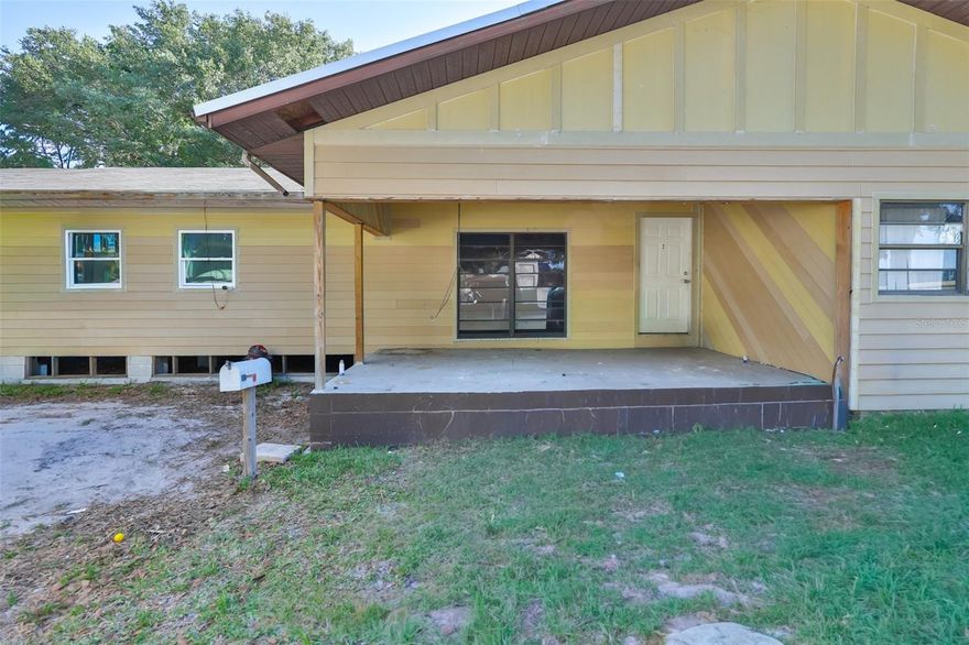 One or more photo(s) has been virtually staged. Enjoy the charm of the 10x32 covered front porch, ideal for relaxing or entertaining guests on a corner lot. This home is packed with potential and ready for your personal touch. In 2023,  a new metal roof, A/C, and well system taking care of the big-ticket items for years to come. A standout feature is the 800 sq ft (32x25) addition, already permitted for plumbing and electrical, offering the perfect opportunity to create a spacious primary suite with room for a second bathroom. No HOA, no CDD.