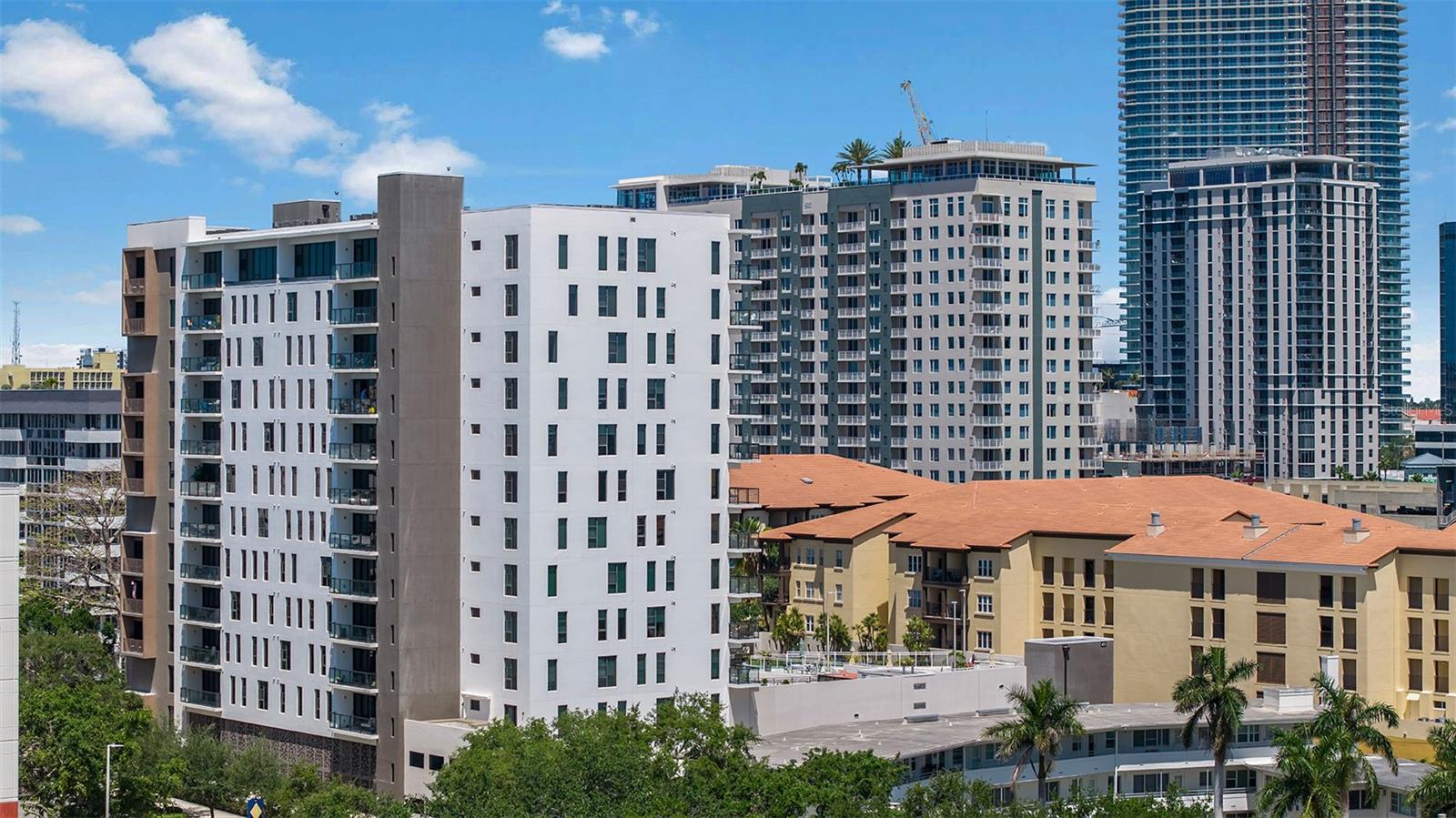 Experience breathtaking, sweeping views of downtown St. Pete, the Pier, Tampa Bay, the Dali Museum, and Albert Whitted Airport from the 12th-floor balcony of this spacious residence at The Salvador. A welcoming Gallery entry sets the tone, offering space for artwork, artistic expression and a direct line of sight to the stunning vistas beyond. This 1,555 sq. ft., 2-bedroom, 2-bath home features a unique open floor plan with windows on three sides—ensuring abundant natural light, dramatic views, and complete privacy with no adjacent units. The expansive living and dining areas are framed by floor-to-ceiling windows, with motorized blackout shades on the East and West exposures. The contemporary kitchen has been thoughtfully upgraded with custom waterfall-edge countertops, a deep single-basin sink with modern faucet, natural gas range, Samsung 28 cu. ft. French door refrigerator with food showcase panel and filtered ice/water, and a wine cooler. Design upgrades continue throughout: premium sinks and Moen faucets in both bathrooms, Cat 6 wiring from a centralized Ethernet switch, and sunshade blinds in both bedrooms, double-hung with blackout layers. The primary suite features a generous walk-in closet and a spa-inspired bath with a deep soaking tub, a large walk-in shower with a custom glass enclosure, dual Moen fixtures (rainhead and handheld), each with individual thermostatic controls, and a dual-sink vanity. The guest bedroom includes a custom queen-size Murphy Bed with swinging bookshelf doors. A laundry closet between the bedrooms includes Samsung front-loading washer and dryer with added storage. This residence includes two adjacent second-floor parking spaces and a substantial climate-controlled storage room. The Salvador, a LEED-certified building with only 74 units, offers an array of amenities including a pool and spa, a state-of-the-art fitness center, a social room, grilling area, dog park with wash station, sculpture garden, and outdoor fire pit. Concierge service and on-site management ensure effortless living in this tranquil yet centrally located oasis, just blocks from downtown attractions like the Dali Museum, Mahaffey Theater, Albert Whitted Airfield, and the vibrant Saturday Morning Market. Elevate your lifestyle with a private tour of this exceptional residence at The Salvador and discover unparalleled luxury living in the heart of St. Pete. Schedule your visit today to immerse yourself in this unparalleled blend of privacy, luxury, and location.