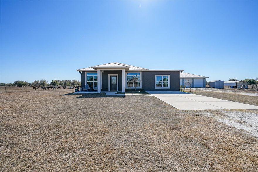 If you’ve been looking for something that feels upgraded, intentional, and still gives you space to breathe… this is it. This fully renovated three bedroom, two bathroom home was built in 2016 and sits on 4.78 acres of usable land, zoned for farm animals and complete with a pond. It’s private, it’s peaceful, and it’s the kind of property that gives you options. Inside, every detail has been elevated. You’ll notice the custom wood accents and archways right away. They add warmth and character without feeling overdone. The kitchen is a standout with two-tone cabinetry, floating shelves, and a layout that actually works. Tucked just behind it is a full butler’s pantry with a second sink, second refrigerator, and serious storage. It keeps the main kitchen clean and functional while giving you space to prep, host, or just spread out. Two of the bedrooms feature oversized walk-in closets that feel more like dressing rooms. The bathrooms are finished with high-end tile work and clean, modern design that feels fresh and timeless. There’s also a dedicated laundry and utility room, because practical spaces matter too. One of my favorite features is the bonus room. It’s large enough to be a fourth bedroom, office, home gym, media room, hobby space, whatever you need it to be. It gives this home flexibility that a lot of properties just don’t have. Outside, you’ve got nearly five acres to enjoy. Zoned for farm animals, so bring the horses, chickens, or start that garden you’ve been talking about. The pond adds charm and makes the whole property feel established and peaceful. A detached two-car garage gives you extra storage and workspace, separate from the main house. This is one of those properties that feels put together. The finishes are high-end. The land is usable. The layout makes sense. And you get the rare combination of luxury inside and freedom outside. It’s polished without being fussy. Private without being remote. And ready for someone who wants space without sacrificing style.