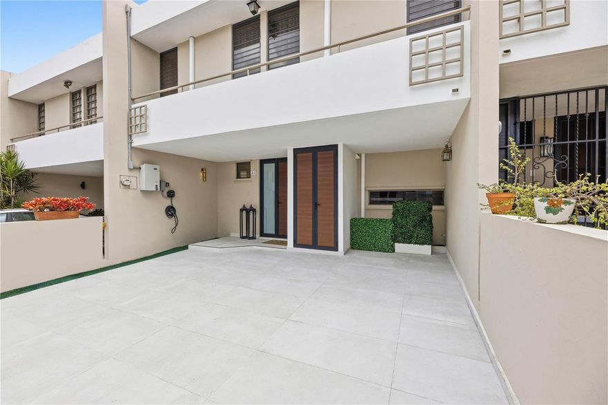 Nestled in the heart of Guaynabo, this stunning townhome at 33 Zuania St. offers the perfect blend of modern luxury and metropolitan convenience. Located within the gated community of Parque de Villa Caparra, the residence provides a tranquil retreat while remaining just moments away from some of the area's top destinations such as San Patricio Plaza and Plaza Caparra. The home features 3 spacious bedrooms, 2 full bathrooms, and a powder room for guests. Showcasing an open-concept layout, the living area maximizes natural light and flow. High-end finishes are evident throughout, from the sleek porcelain flooring to the custom lighting fixtures and designer wall treatments. Equipped with a dedicated laundry nook, premium cabinetry, and stone countertops, the modern kitchen seamlessly connects to a tasteful dining area perfect for entertaining. For added comfort and ease, the property includes a driveway with electric car charger and space for 2 vehicles. This residence is a rare find for those looking for a move-in ready rental offering within one of Guaynabo's most coveted suburban enclaves. Enjoy immediate access to fine dining, luxury retail, schools and a variety of entertainment options. A short drive away from San Juan, Isla Verde and Dorado.