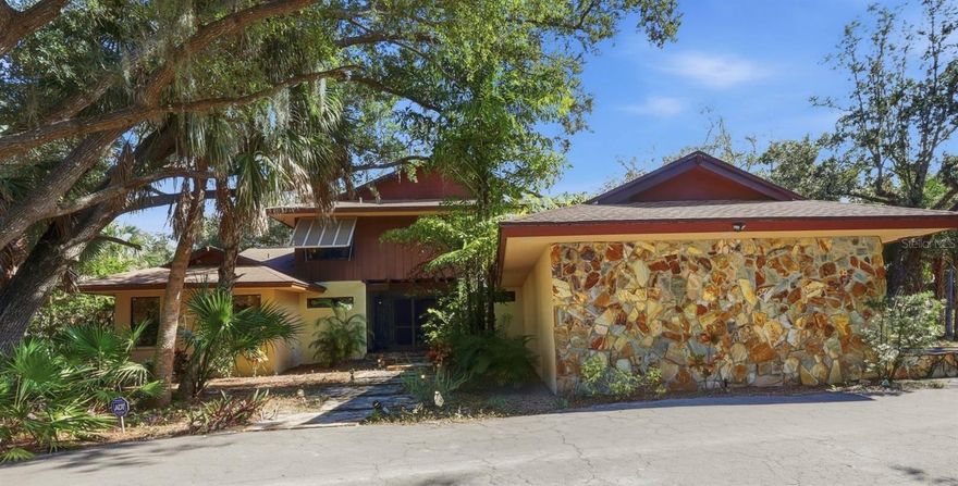 One or more photo(s) has been virtually staged. AMAZING OPPORTUNITY . . . 2 PRIVATE HOMES on ONE HOMESITE . . . A One-of-a-Kind CUSTOM-BUILT PRIVATE ESTATE Offers a MAIN HOUSE and a GUEST HOUSE with a Pool & Spa Featuring 6 Bedrooms, 3.5 Baths plus a 3-Car Garage on 1.46 Acres Hidden in the Very Heart of Port Charlotte Providing the Rare Opportunity for a Fantastic Family Compound, or Multi-Generational Living. This Property is Private, Secluded and Lusciously Landscaped.  Relax by the Pool, or Lounge Away in the Hot Tub Amongst the Tropical Plantings and Let Your Mind Drift Away. Various Members of Your Family Can Find Their Own Nirvana in this Expansive Property. Once Inside the Main House, You’ll Discover 5 Bedrooms and 2.5 Baths and Nearly 4,000 sq. ft of Living Space. The First Floor Primary Suite with DOUBLE Walk-In Closets and a Bonus Bedroom. . . (Nursery/Solarium/Den/Office) Provides Ultimate Solitude and Privacy from the Rest of the Estate. The Luxurious Primary Bath has a Jacuzzi-Style Tub, Fully Tiled Spacious Shower and Dual Sinks and Vanity.  The Heart of this Home is the Spectacular Wood-Beamed Cathedral Ceiling Soaring Approximately 30 Feet in Height in the Enormous Family Room (15 X 36.8) with a Magnificent Wood Burning Fireplace, Featuring a Copper Fireplace Hood. Wood Custom-Built Bookshelves Line the Family Room Creating an Old World-Style Décor. TILE FLOORS can be Found Throughout the 1st Floor of the Main House.  Carpeted Stairs Lead to the 2nd Floor where You’ll Find 3 Generously Sized Bedrooms and a Super-Sized Bathroom with Dual Sinks and Extra Long Vanity, Plus an Over-Sized Shower.  This Incredible Property Offers  the Unique Luxury of Having a SEPARATE ON-SITE GUEST HOUSE, In-Laws House, or Au Pair Quarters (1536 sq. ft. with a NEW Metal Roof in 2022). Featuring its’ own Stone-Masonry Wood Burning Fireplace that climbs to the Cathedral Ceiling with Solid Wood Beams in the Great Room, and Vaulted Ceilings in the Office/Den, Bedroom, and Spacious Bathroom. This RETREAT will be a Welcome Oasis for an Artist, or Family Member. Mexican Tile is Featured Throughout the Entire Guest House. The Tranquility You’ll Find in this Outstanding Property is so Incredibly Rare in Today’s Hectic World.  Conveniently Located a Few Minutes from Tamiami Trail (SR 41) its Within 10 Minutes of Two Hospitals (Making it an Ideal Location for Doctors) and within Minutes of Shopping, Restaurants, the Port Charlotte Town Center Mall, Golf, Boating, and Fishing. Located 30 Minutes from Beautiful Englewood Beach and Boca Grande. Make Your Appointment Today to See this Amazing Complex Where You Will Find Peace and Solitude, and Where the Stress of Everyday Life Just Melts Away.  Welcome to Paradise