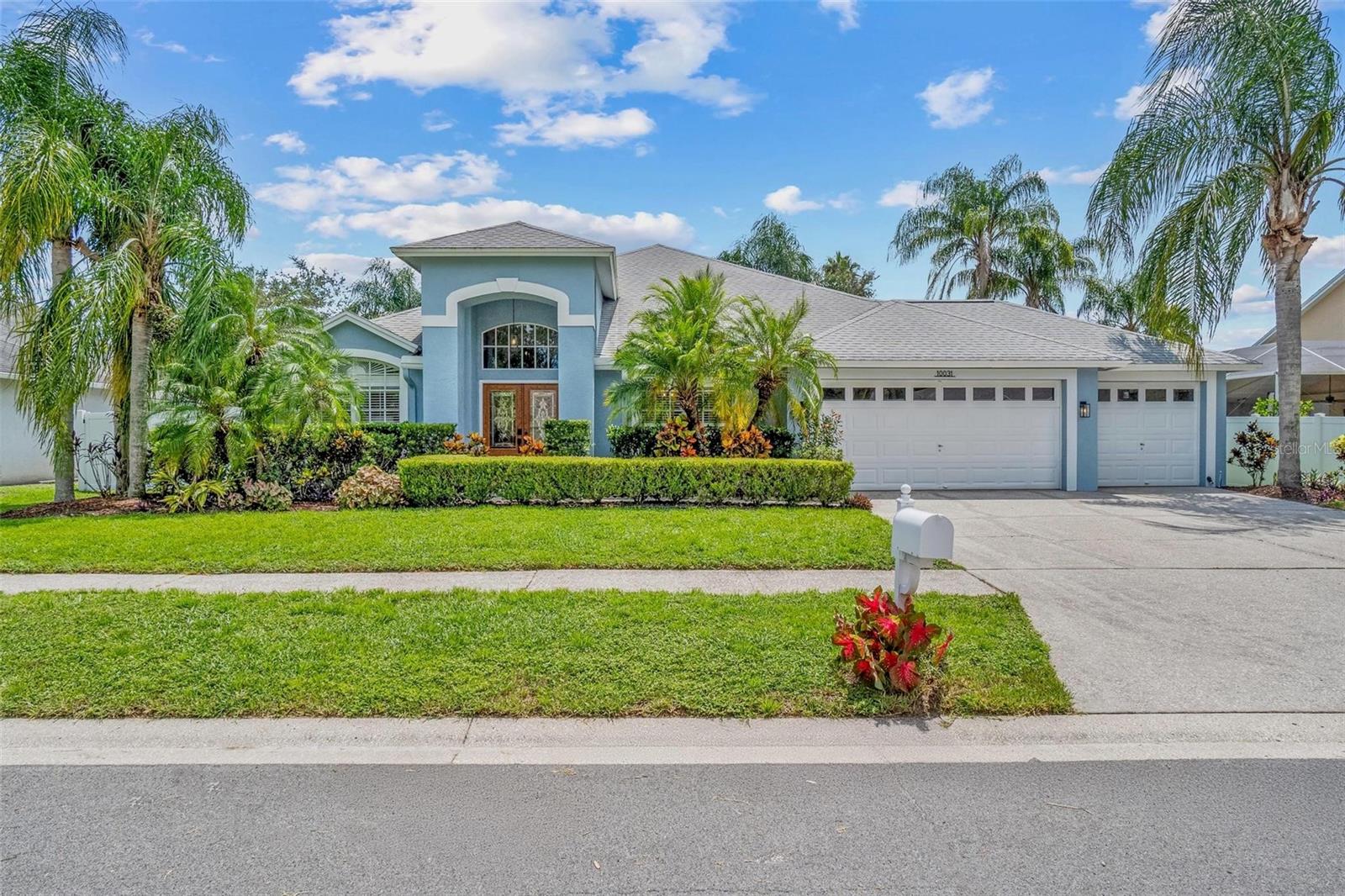 Don’t miss this executive style home with beaming high ceilings and complete with over 2,500 square feet of living space with 4 bedrooms, 3 full bathrooms, and the unique 3-car garage! The kitchen has been upgraded with quartz countertops, slate appliances, and a cozy breakfast nook, making it a great spot for cooking and gathering. All 3 bathrooms feature high-end finishes, including granite countertops, and the master bathroom with walk-in shower, soaking tub, and double vanities is as spacious as it gets! Plantation shutters and upgraded lighting fixtures are installed throughout the home creating a more elegant feel, and the living room stands out with a beautiful granite-surround fireplace and plenty of room for everyone. You'll also appreciate the newly-installed whole-house Culligan water system! Out back, there’s a large tiled screened-in lanai with a wet bar and it all looks over a fenced yard on a larger-than-average lot. The HOA is chalked full of amenities: swimming pool, tennis/pickleball court, baseball field, basketball court, playgrounds, dog park, fitness trail and community center. Located a stone's throw from The Shops at Wiregrass inside of a mature, quiet community, you're a also short car ride to downtown Tampa. Come see it!