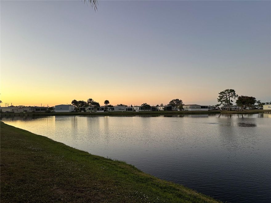 Adorable lakefront home is waiting for a new owner in the resort like community of Harbor Isles. Immaculate amenities and a myriad of activities year round. First come, first serve marina includes a kayak and canoe launch, fishing station, pavilion, and boat slips. This home features an extra deep carport, an enclosed breezeway between the Florida room and utility room, brand new plywood subfloors with luxury vinyl throughout, freshly painted interior, updated windows, a new electric panel in 2024, a shingle roof from 2023, and a brand new air conditioning system. The kitchen offers newer appliances, counters, and tile flooring. Both bedrooms include walk in closets, and the bathrooms have updated vanities and toilets. The Florida room adds an additional 247 square feet of living space and showcases sweeping lake views, making it the perfect spot to enjoy morning coffee or an afternoon libation. This home is ready for your personal touches and offers a true slice of paradise. Conveniently located near the Atlanta Braves ball field, downtown Wellen Park, beaches, shopping, dining, library, churches, interstate access, airports, and more. Call today for your personal tour.