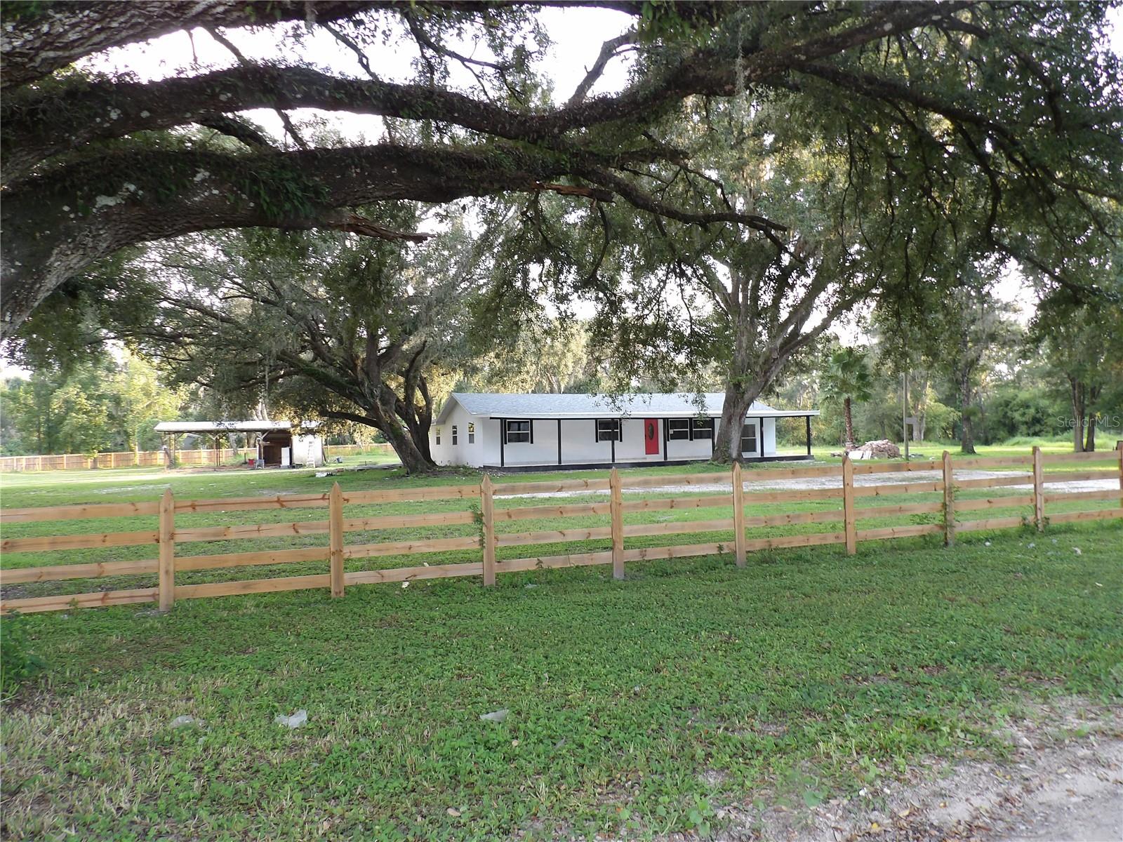 Experience the freedom and tranquility of the countryside in this spacious home located on Cristal Springs Colony farms. This property features a 5 bedroom, 4 bathrooms, both indoor, and outdoor kitchen, an a very large open front porch 60x12 feet, additionally there is a spacious back porch which include an outdoor kitchen, located under roof on a large back porch 16x30. The home is on 5 acres of land and plenty of room to roam. Whether you're envisioning space for horses, raising chickens, goats, cows, or even having a garden for your RV or a custom workshop, this property perfectly combines comfort, functionality, all without HOA restrictions. Additionally, his property also features 24' x 44' Pavilion perfect for an outdoor gathering Large enough for multiple picnic tables, there is ample room for any event requiring shelter and shade. The property is beautifully fenced and also features two small ponds and an outdoor grill area for your guests. Additionally, there is a detached carport with a workshop and a men cave. completely remodeled Just 20 minutes to all of the amenities that Wesley Chapel has to offer, and 30 minutes to the bustling cities of Tampa and Lakeland, you have everything you would need just a short drive away. This is truly the ideal blend of rural charm and urban accessibility! Don’t miss your chance to make your mark on this incredible piece of land.