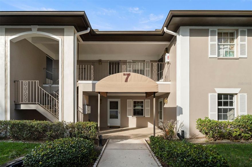 Welcome to this ground-floor residence in the well-maintained Bay Oaks Condo community. Nestled in Building 7, located in a NO-flood zone, this unit offers privacy and peace of mind in a quiet setting. This unit features a bright, open floor layout with wood-look tile throughout the main living areas. The kitchen is thoughtfully designed with stainless steel Whirlpool appliances, a breakfast bar, and ample cabinet and counter space for everyday living and entertaining. The generously sized bedroom includes a walk-in closet, and the updated bathroom showcases neutral tile and a modern vanity. A washer and dryer are included, and there is plenty of storage throughout the unit. Enhancing the home is a windowed, screened-in solarium—ideal for year-round use and easily accessible from both the living room and bedroom. Additional highlights include a covered, reserved parking space directly in front of  the unit and plenty of guest parking. Bay Oaks is a quiet, all-ages, pet-friendly community offering mature oak trees, lush landscaping, a community pool, and a pond with a fountain. Shopping is located directly across the street, and the $470/month HOA fee covers cable, internet, sewer, trash, pool, and grounds maintenance.