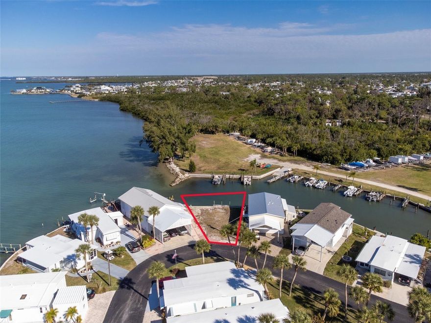 Attention Boaters and Fisherman!!! Here is your chance to be in an Incredible Location in the gated 10 acre Waterfront Community of Park Pointe Mobile Home Village. This Waterfront Lot has beautiful views of the Intercostal Waterway with direct access to Lemon Bay and Stump Pass from the Park’s private marina and boat ramp. The lot has it's own private boat slip. Slips for boats up to 24’ long are also available in the marina for $40/month, which includes off season outdoor boat storage. Stump Pass Marina and the Lighthouse Grill are located next to the Park. Community amenities include an on site office manager, clubhouse, heated pool, spa, on site laundry, gated entry, boat storage lot, community marina and boat ramp, fish cleaning table, and a picnic and kayak launch area on the water. Park Pointe is a 54 unit co-op in which you own 1 share of stock valued at 1/54 of the market value of the Park’s assets. A rotating Board of Directors elected from the stockholders manages the Park and keeps monthly fees as low as possible. Don’t miss out on this opportunity to put your a new manufactured home on this beautiful lot. Start living the best of the Florida lifestyle. Close to world famous Tarpon fishing on Boca Grande, beaches, shopping, dining and Tampa Bay Rays and Atlanta Braves spring training facilities. Imagine the possibilities!