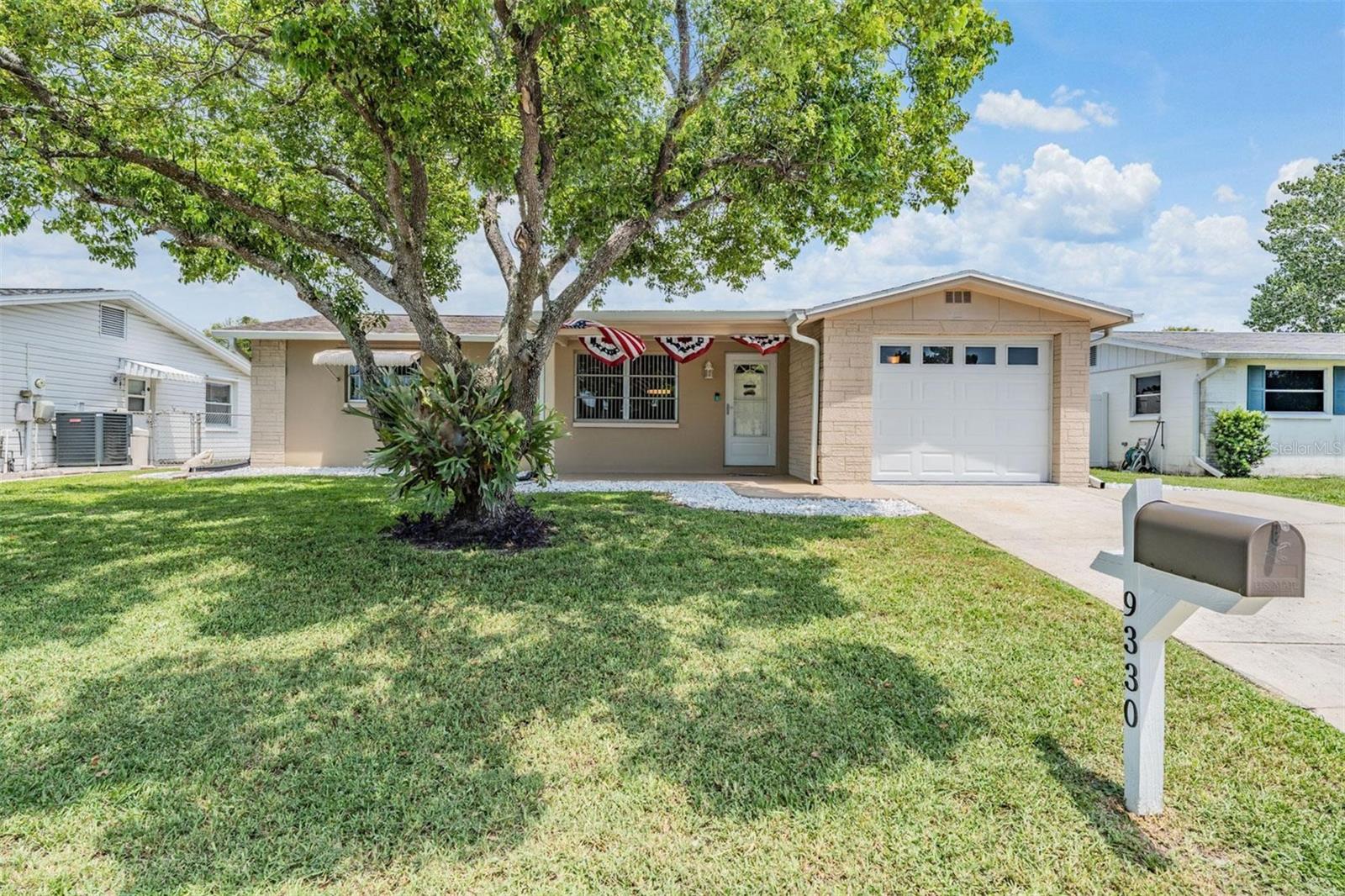Make this adorable beachy bungalow your very own! This home has everything you need and is conveniently located to restaurants, the Gulf, and downtown New Port Richey. When you enter this home you will find a spacious and open living area, which extends out to your enclosed bonus room. From here you will also find a screened patio, making for plenty of space to relax and enjoy the beautiful Florida sunshine. You will find two bedrooms, and a shared bathroom down the hallway. This home has been deep cleaned and impeccably maintained. The garage has been recently epoxied, a full home Maytag water treatment system was added in 2024, water heater is new as of 2024. Schedule your private showing today!