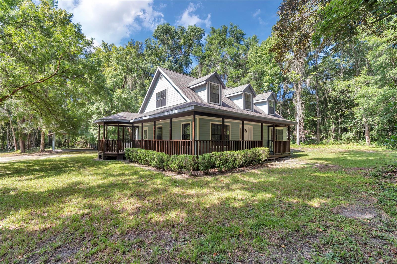 This is the property you have been looking for! This cottage retreat-like property features 4 Bedrooms and 2.5 bathrooms and is situated on 3.3 acres of serene land, perfect for those seeking tranquility and space. Upon entering the home, you'll be welcomed by warm and inviting interiors featuring brand-new floors and freshly painted walls, doors and trim. The oversized kitchen is perfect for preparing meals and entertaining guests. The first floor also includes a separate dining room, a great room, a laundry room, a half bath, and the primary bedroom with its own bathroom and walk-in closet. Upstairs, you'll find two spacious bedrooms and an additional bedroom that can be used as your office, yoga studio, hobby room, etc...each with ample closet space and large windows that offer views of the property. Outside you will find a wrap around porch, perfect for enjoying your morning coffee and relaxing in a rocking chair. The property also features a carport accommodating two vehicles or other toys and a fenced in area for pets. Saddle Hill is located in Horse Country, a highly desirable area in Marion County, FL. Located 5 minutes from I-75, 20 mins to Gainesville for UF, Shands, restaurants and retail and is only 20 mins to the world-class World Equestrian Center in Ocala. Perfect for hobby farmers, equestrians, or those seeking rural tranquility with easy access to city conveniences. NO HOME OWNERS ASSOCIATION & NO FEES. Roof replaced in 2016, AC replaced in 2024, and 200 AMP service replaced in 2024. This home truly takes you back to the days when life felt more simple. When you see it you will love it!