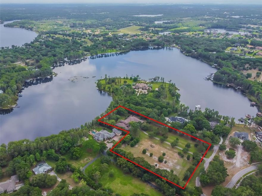 PRICE IMPROVEMENT - THE BEST VALUE IN ODESSA! SELLER HAS A RECENT APPRAISAL FOR $3.4 MILLION! INSTANT EQUITY SITUATION FROM DAY 1 WITH EVEN MORE VALUE ADD POSSIBLE WITH UPGRADES AFTER PURCHASE! A once in a lifetime WATERFRONT ESTATE located on highly desirable Lake Alice! This property provides tons of versatility being zoned ASC-1. Make your Equestrian, sports complex, garage, or future entertainment dreams a reality with this extremely rare opportunity! Enjoy the 234 feet of lake frontage lined with Cypress Trees as Lake Alice is a well sized 87 acre lake known for its crystal clear waters! Go through the wrought iron gates to an extended driveway that takes you to this stunning CUSTOM-BUILT HOME. Be greeted to stunning CURB APPEAL with breath taking ARCHITECTURAL FEATURES, unique ELEVATION, and an oversized brick paved motor court. Featuring 8.94 acres with 6.06 acres high and dry, 9,200 sq ft of generous living space, 2 kitchens, 2 dining/family rooms, 8 bedrooms, 5.5 bathrooms, split 7 car garage, 2 patios, 2 outdoor kitchens, a grandfathered pavilion, theatre room, 3 wet bars, and so much more! This property is perfect for EXTENDED FAMILY living as the left side offers a 3 bedroom, 2 bath while the main home offers a 5 bedroom, 3.5 bath on the right side. The spaces are divided by a shared foyer in the front with access to each side. You will take notice of the beautiful Travertine floors that sprawl throughout the main living spaces with an abundance of NATURAL LIGHT coming from all the windows with tranquil Lake views. The family room showcases a stone fireplace and runs into the LUXURIOUS KITCHEN that offers more LAKE VIEWS, GRANITE COUNTERS, CUSTOM CABINETRY, OVER-SIZED ISLAND, STAINLESS STEEL appliances, granite BACKSPLASH, and pantry. Pass your OFFICE on the way to your primary suite that offers a retreat from everyday life with great walk-in closets. Primary bath features lots of room with double sinks and beautiful large shower! All bedrooms are extra-large with generous walk-in closets. The THEATRE ROOM has a bar for entertaining & enough room to sprawl out for family movie night or game day! Live the FLORIDA LIFESTYLE lounging on one of your COVERED PATIOS overlooking Lake Alice and the lush estate. All while being perfectly located in the A+ Steinbrenner school district close to the Tampa International Airport, Veteran's Expressway, shopping, dining options, medical, & everything Tampa Bay has to offer! This property was built commercial grade and there are too many other features to list. A floor plan and upgrade sheet are available upon request. Make your private appointment today!