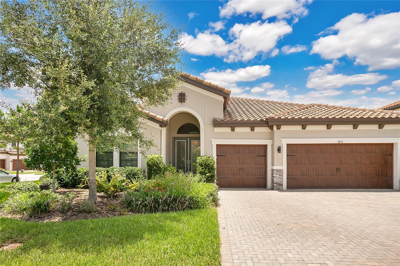 Located in the award-winning community of Starkey Ranch, this stunning 4-bedroom, 3-bathroom smart home offers the perfect blend of luxury, functionality, and modern convenience. Featuring tall ceilings and doors throughout, a gorgeous coffered ceiling and brick accent wall in the living room, and an extended gourmet kitchen, this open-concept home is designed for comfortable living and effortless entertaining. A versatile flex space provides the perfect setup for a home office, playroom, or home gym to suit your needs. Smart upgrades include a smart thermostat, hardwired 360 security cameras, motorized curtains in the living room, Forever Christmas lights, and a Stage 2 Tesla charger in the garage. The spacious primary suite boasts an oversized walk-in shower, dual vanities, and large closets, while the additional bedrooms provide flexibility and comfort for family or guests. Enjoy life in Starkey Ranch, one of the most desirable master-planned communities in the area, with access to miles of scenic trails, community parks, pools, playgrounds, and a top-rated K-8 school right within the neighborhood. Move-in ready and loaded with thoughtful upgrades, this home offers an exceptional lifestyle in a truly unbeatable location.