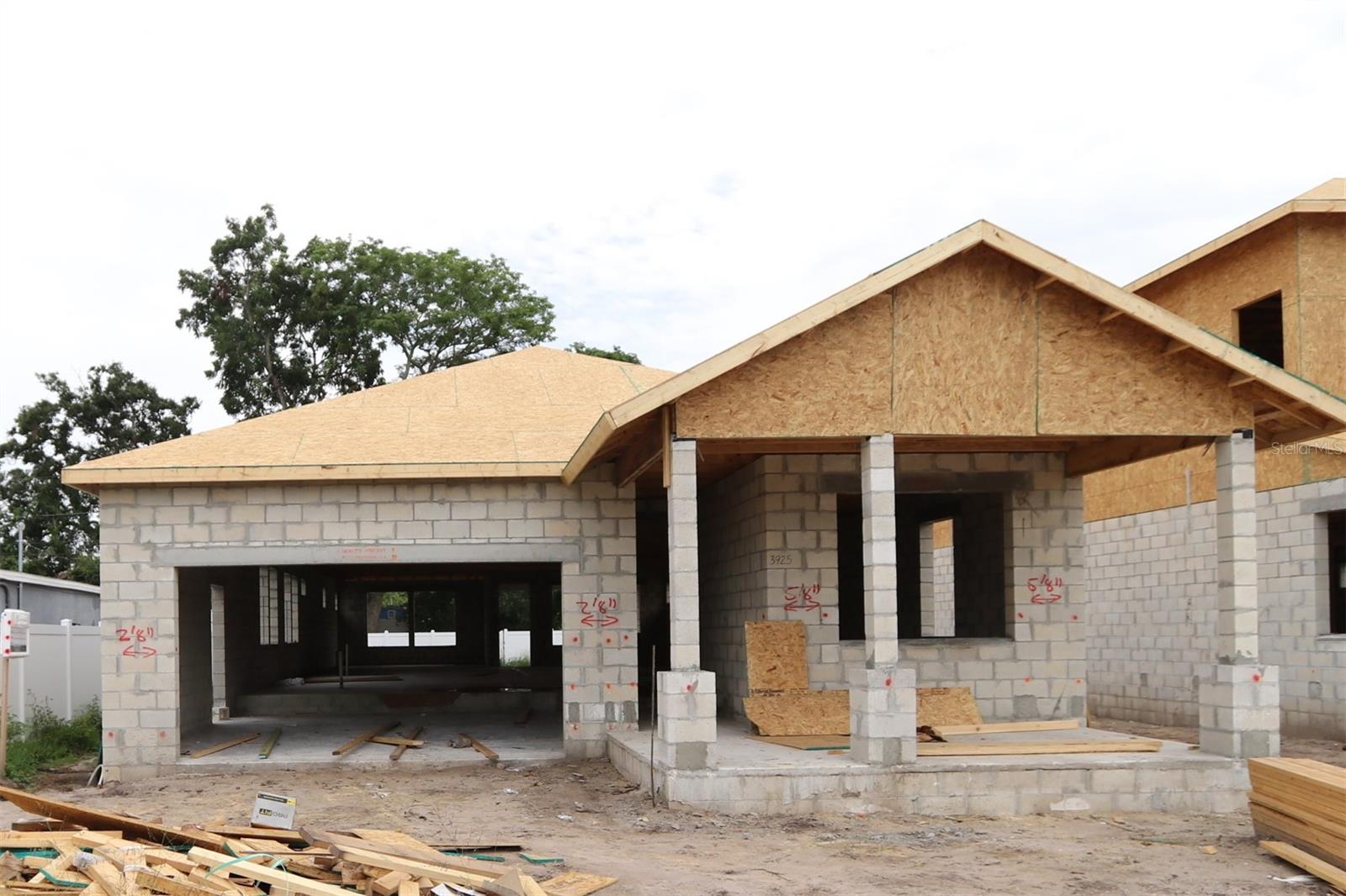 Under Construction. Step into this stunning new David Weekley home in St. Pete, where the exterior's unique blend of stucco and board-and-batten accents immediately captivates. As you enter, you'll be greeted by a welcoming foyer that effortlessly leads you through the thoughtfully designed floor plan. The guest bedrooms are positioned at the front of the home, while the Owner’s Retreat is tucked privately at the rear for ultimate serenity. Experience an abundance of natural light flowing throughout, offering picturesque views of the lush landscaping just beyond the windows. The expansive Study, complete with French doors, creates a peaceful environment perfect for work or relaxation. Entertaining is effortless in the open-concept kitchen, which boasts elegant quartz counter tops and a large island ideal for gathering. The spacious dining area is perfect for hosting friends and family, easily accommodating a large table and buffet. Relax in your private backyard oasis, spending peaceful evenings on the covered lanai. This home offers exceptional quality, energy efficiency, and peace of mind with a comprehensive 1, 2,10-year warranty. Reach out to our sales team today for more details and make this your dream home! Some photos and virtual tours are of a similar, completed “Crestview” home for comparison purposes only and may show options/features no longer available.