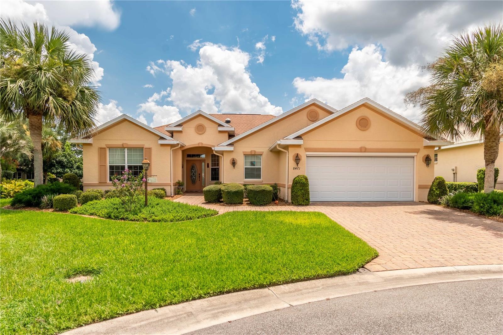 This beautifully maintained 3-bedroom, 2-bath home sits on an extra-large lot and offers a perfect blend of comfort and functionality. The spacious kitchen features solid surface counters, while the extended, fully enclosed lanai with wall-to-wall windows and custom shades provides a bright and relaxing retreat. Additional upgrades include garage and lanai ceiling insulation with vents, garage door screens, and full irrigation in the front, back, and side yards. A Trane HVAC system, tankless hot water heater, water softener, and bidet ensure modern convenience, while gutters add peace of mind. This home is truly move-in ready with thoughtful touches throughout.