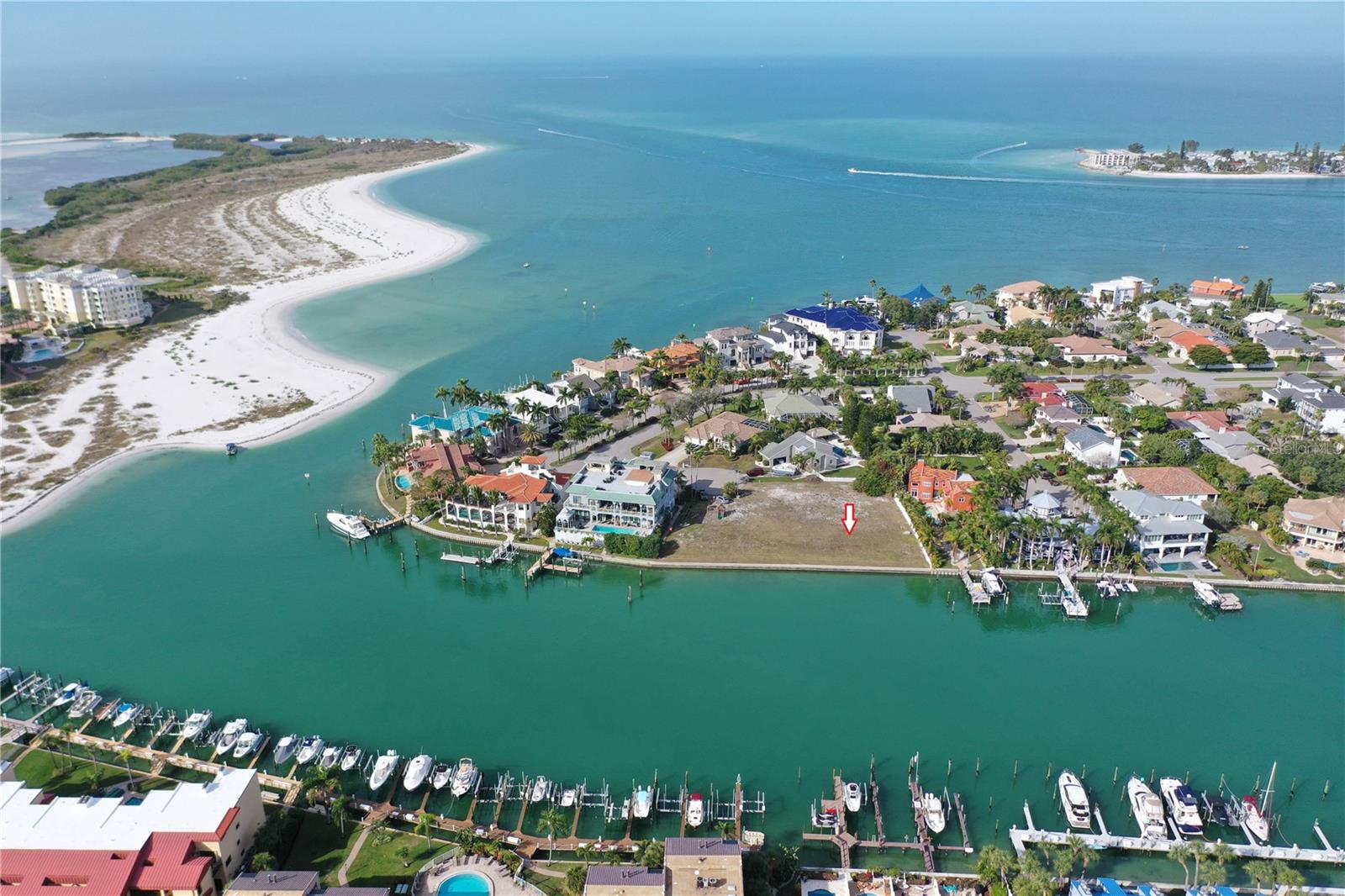 Discover the epitome of waterfront living with this exceptional deep-water lot on the Grand Canal in Tierra Verde. This rare opportunity allows you to design your dream home on a premier piece of paradise. Spanning 74.8 feet of direct waterfront access on a generous 66 x 171 lot, this property is a true haven for boat enthusiasts. Savor the refreshing breezes while watching dolphins and manatees glide by.
Positioned at the entrance to the Grand Canal, this lot offers quick and easy access to the Gulf of Mexico, the Intracoastal Waterway, and Tampa Bay, making it an ideal location for boating adventures. In addition to its unrivaled water access, the property is just minutes from world-famous beaches and the iconic Fort De Soto Park. Perfectly situated, the lot is only about 30 minutes from Tampa International Airport and St. Pete-Clearwater International Airport, with I-275 just 10 minutes away. This prime location allows for quick connections to downtown St. Petersburg (15 minutes), downtown Tampa (40 minutes), and Sarasota International Airport (50 minutes), ensuring convenient travel options for those with a jet-set lifestyle. Immerse yourself in the vibrant local culture with nearby restaurants, beautiful beaches, and the bustling downtown St. Petersburg area. Don’t miss the chance to own this rare piece of waterfront tranquility in Tierra Verde—where every day feels like a vacation in paradise.