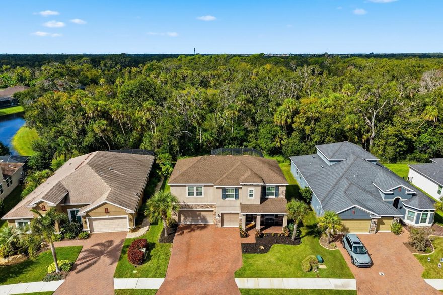 Enjoy easy living in this newer and spacious home in the highly desirable gated community of Oakleaf Hammock.  This 2018-built home features a generous 3,201 square feet with 5 bedrooms, 3.5 bathrooms and 3 car garage.  The primary suite is conveniently located on the main floor and boasts a tray ceiling, plantation shutters, extra spacious walk-in closet, en-suite bath with garden tub and dual sink quartz countertop.
Modern white cabinetry in the kitchen also featuring a large center island, stainless steel appliances, quartz countertops and walk in pantry.  Additional breakfast nook looking out to the living room also with tray ceiling and expansive sliders that open to a large pavered lanai and heated saltwater pool—perfect for relaxing or entertaining.
Enjoy the privacy of a quiet backyard nestled on a large preserve, providing a serene backdrop. The home includes a large upstairs bonus room, exceptional closet space, and plantation shutters and crown moulding throughout. Recently added updates include an 80 gallon hot water heater, a portable generator with an electric transfer switch and supplemental A/C for uninterrupted comfort. Safe and up-to-date, the house features all new hard-wired smoke and carbon monoxide detectors.
Located in a low HOA gated community with NO CDD, residents have access to amenities including a playground, picnic pavilion, and basketball court. This exceptional home combines comfort, style, and security—ready for you to make it your new sanctuary!