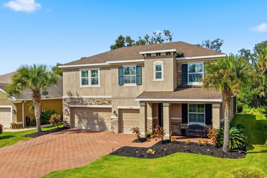 Enjoy easy living in this newer and spacious home in the highly desirable gated community of Oakleaf Hammock.  This 2018-built home features a generous 3,201 square feet with 5 bedrooms, 3.5 bathrooms and 3 car garage.  The primary suite is conveniently located on the main floor and boasts a tray ceiling, plantation shutters, extra spacious walk-in closet, en-suite bath with garden tub and dual sink quartz countertop.
Modern white cabinetry in the kitchen also featuring a large center island, stainless steel appliances, quartz countertops and walk in pantry.  Additional breakfast nook looking out to the living room also with tray ceiling and expansive sliders that open to a large pavered lanai and heated saltwater pool—perfect for relaxing or entertaining.
Enjoy the privacy of a quiet backyard nestled on a large preserve, providing a serene backdrop. The home includes a large upstairs bonus room, exceptional closet space, and plantation shutters and crown moulding throughout. Recently added updates include an 80 gallon hot water heater, a portable generator with an electric transfer switch and supplemental A/C for uninterrupted comfort. Safe and up-to-date, the house features all new hard-wired smoke and carbon monoxide detectors.
Located in a low HOA gated community with NO CDD, residents have access to amenities including a playground, picnic pavilion, and basketball court. This exceptional home combines comfort, style, and security—ready for you to make it your new sanctuary!