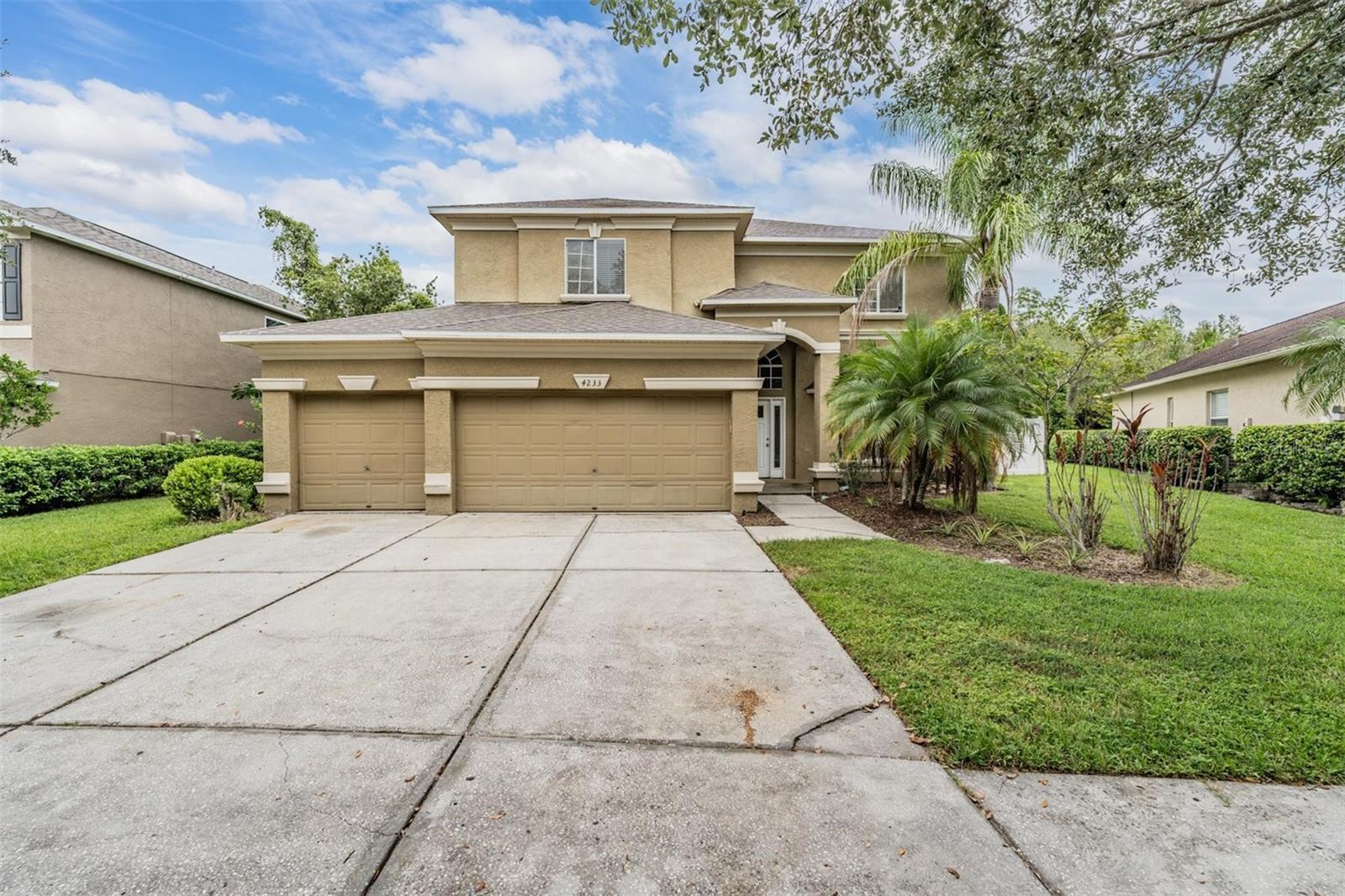 One or more photo(s) has been virtually staged. Welcome to your spacious Florida pool retreat! This 5-bedroom, 3-bathroom home is nestled in the heart of Lutz in a desirable community setting. With over 3,000 square feet of living space, this two-story home offers the perfect layout for families and entertainers alike. Step inside to find an open-concept floor plan featuring multiple living and dining areas, a generous kitchen with granite countertops, stainless steel appliances, a center island, and ample cabinetry. The large windows throughout the home fill the space with natural light and offer views of the screen-enclosed pool and spa, perfect for year-round enjoyment. The expansive primary suite includes a spacious bedroom, walk-in closet, and a large en-suite bath complete with a soaking tub and separate shower. All bedrooms are well-sized and offer flexible space for guests, home offices, or hobby rooms. Enjoy Florida living at its best with a private backyard oasis, complete with a screened lanai, pool, and spa, all surrounded by mature landscaping for added privacy. A 3-car garage offers plenty of room for vehicles and storage. Located near shopping, dining, top-rated schools, and major highways for easy commuting. With tons of potential and great bones, this home is a blank canvas ready for your personal touch!