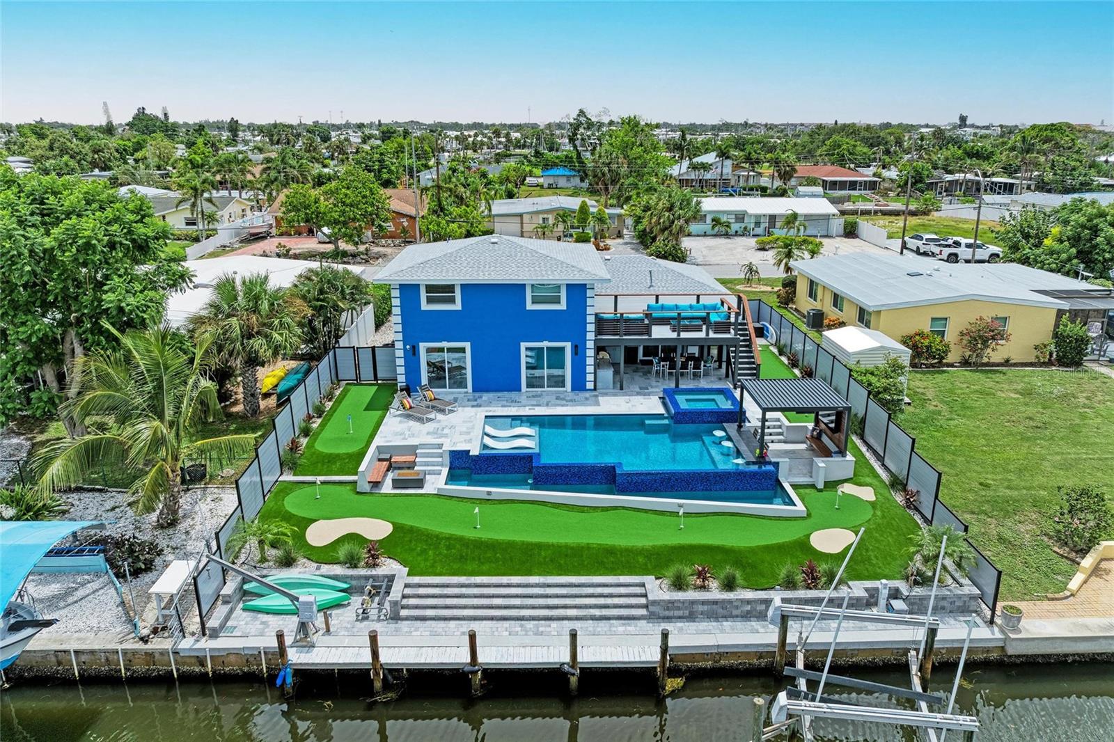 Coastal Luxury Meets Waterfront Adventure – Deep Water Canal Home with Resort-Style Amenities
Welcome to your private waterfront paradise called Edgewater Luxe, where luxury, leisure, and location converge on a deep-water canal just minutes from the open expanse of Sarasota Bay. Boasting 70 feet of seawall, this exceptional property offers direct boating access to the Gulf and includes a private dock with electric and water, accommodating up to a 26’ boat, plus a jet ski lift—the ideal setup for serious boaters and water-lovers alike.
Step inside this expansive 5-bedroom, 3-bathroom residence and immediately feel at home. Perfectly designed for entertaining, the property flows seamlessly from indoor comfort to incredible outdoor living, crowned by a one-of-a-kind rooftop deck offering panoramic views of the water and your own personal oasis.
The crown jewel of this estate? A $400k+ custom-designed, heated infinity pool and spa complete with a swim-up bar, all set against the backdrop of the glistening canal. Lounge in the sunken pergolux poolside with automated louvers and LED lights under a mounted TV, catch the big game, or unwind with your favorite show—right from the water. Surrounding the pool is a 6-hole putting green, a fire pit lounge area, and ample space for al fresco entertaining.
Just off the home, enjoy a fully covered outdoor kitchen and dining space, perfect for coastal evenings spent with family and friends. A newer roof and HVAC system, along with numerous interior and exterior upgrades, make this home turn-key and move-in ready. For added convenience, a 12x24 parking pad offers dedicated space for your boat trailer or extra vehicle.
Zoned in the desirable AE/X flood zone, this property remained high and dry through recent hurricanes, providing added peace of mind. And with no deed restrictions, the home is eligible for nightly and weekly rentals, offering exceptional income potential for short-term vacation stays.
The neighborhood is an amenity-rich gem, featuring a private recreational center with marina, tennis courts, swimming pool, clubhouse, playground, beach area, kayak launch, and fishing pier—all for just $10/year.
Located mere minutes from Sarasota Airport, downtown Sarasota, shopping, and IMG Academy, this home is a rare combination of location, lifestyle, and luxury. With Sarasota Bay—a majestic, 22,500-acre boating and fishing haven—as your playground, this is truly coastal living at its finest.
All measurements approximate, please verify. All rental restrictions and non restrictions to be verified by buyer through Manatee County.