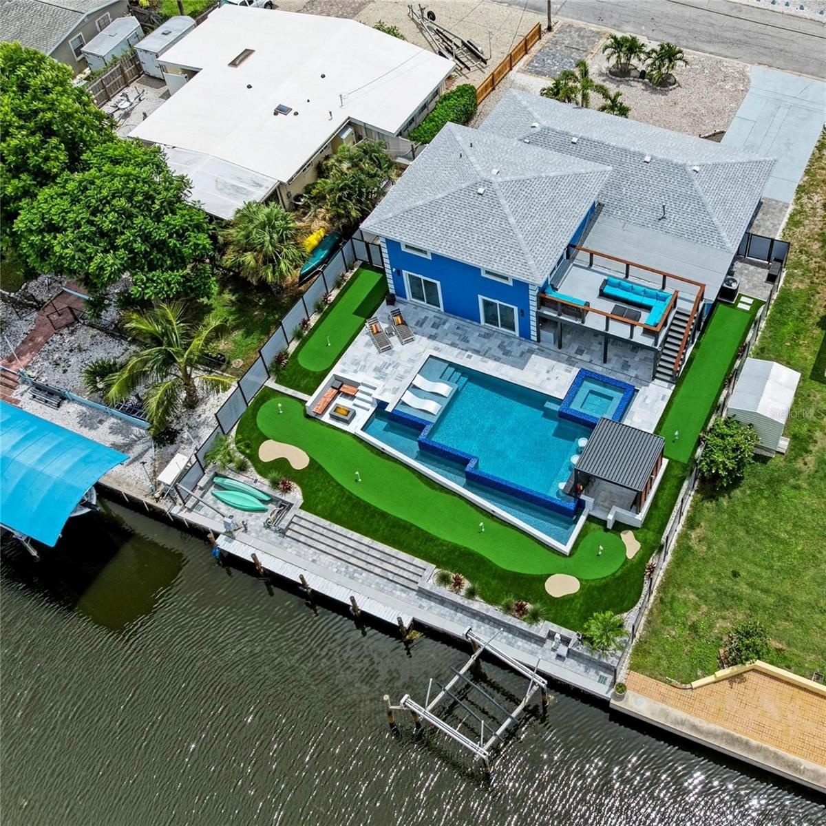 Price reduction! Investors you will not want to miss this one! Average property income $200K/yr on rental revenue. NO Island traffic here, Property/House stayed dry last year.
Coastal Luxury Meets Waterfront Adventure – Deep Water Canal Home with Resort-Style Amenities
Welcome to your private waterfront paradise called Edgewater Luxe, where luxury, leisure, and location converge on a deep-water canal just minutes from the open expanse of Sarasota Bay. Boasting 70 feet of seawall, this exceptional property offers direct boating access to the Gulf and includes a private dock with electric and water, accommodating up to a 26’ boat, plus a jet ski lift—the ideal setup for serious boaters and water-lovers alike.
Step inside this expansive 5-bedroom, 3-bathroom residence and immediately feel at home. Perfectly designed for entertaining, the property flows seamlessly from indoor comfort to incredible outdoor living, crowned by a one-of-a-kind rooftop deck offering panoramic views of the water and your own personal oasis.
The crown jewel of this estate? A $400k+ custom-designed, heated infinity pool and spa complete with a swim-up bar, all set against the backdrop of the glistening canal. Lounge in the sunken pergolux poolside with automated louvers and LED lights under a mounted TV, catch the big game, or unwind with your favorite show—right from the water. Surrounding the pool is a 6-hole putting green, a fire pit lounge area, and ample space for al fresco entertaining.
Just off the home, enjoy a fully covered outdoor kitchen and dining space, perfect for coastal evenings spent with family and friends. A newer roof and HVAC system, along with numerous interior and exterior upgrades, make this home turn-key and move-in ready. For added convenience, a 12x24 parking pad offers dedicated space for your boat trailer or extra vehicle.
Zoned in the desirable AE/X flood zone, this property remained high and dry through recent hurricanes, providing added peace of mind. And with no deed restrictions, the home is eligible for nightly and weekly rentals, offering exceptional income potential for short-term vacation stays.
The neighborhood is an amenity-rich gem, featuring a private recreational center with marina, tennis courts, swimming pool, clubhouse, playground, beach area, kayak launch, and fishing pier—all for just $10/year.
Located mere minutes from Sarasota Airport, downtown Sarasota, shopping, and IMG Academy, this home is a rare combination of location, lifestyle, and luxury. With Sarasota Bay—a majestic, 22,500-acre boating and fishing haven—as your playground, this is truly coastal living at its finest.
All measurements approximate, please verify. All rental restrictions and non restrictions to be verified by buyer through Manatee County.