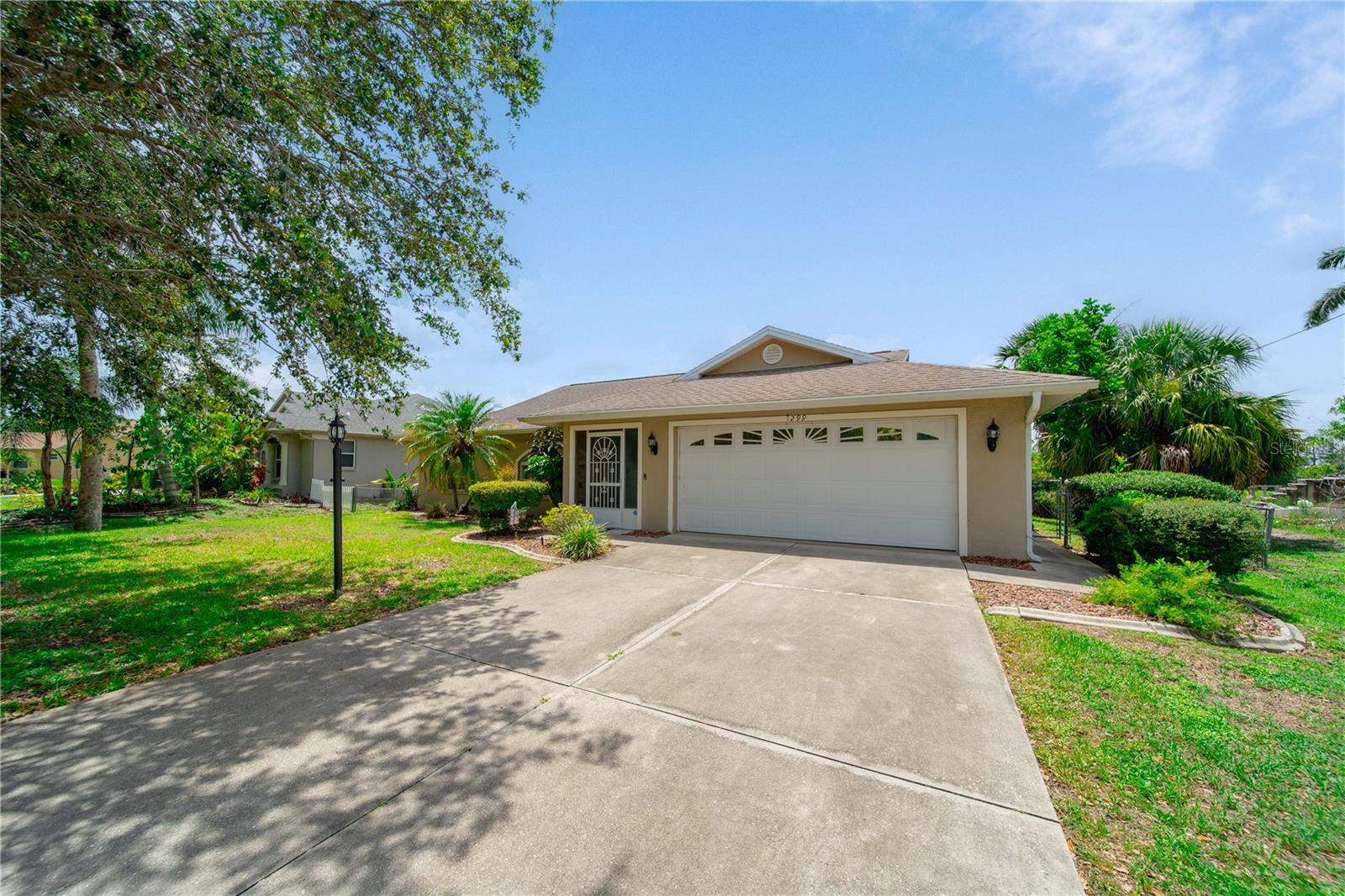 Welcome to 1299 Tripoli Street, a well-maintained 3-bedroom, 2-bathroom home located in the peaceful Port Charlotte Subdivision 10 of North Port. Built in 1997, this charming residence offers 1,421 square feet of comfortable living space and sits on a canal-front lot, providing added privacy and serene water views. The home features a split-bedroom floor plan, vaulted ceilings, and large windows that allow natural light to fill the interior. The kitchen is equipped with ample cabinetry, a breakfast bar, and opens to the dining and living areas—ideal for entertaining or everyday living. The primary suite includes a walk-in closet and en-suite bath with a walk-in shower, while the two additional bedrooms are perfect for guests, a home office, or family. A covered and screened lanai overlooks the fenced backyard and canal, making it a great space to relax, garden, or enjoy the peaceful surroundings. Recent updates include a roof replacement in 2021 and a new water heater installed the same year. Additional features include an indoor laundry room, a two-car garage, city water and sewer, no HOA, and no flood zone. Conveniently located near I-75, shopping, dining, parks, and beaches, this home is a perfect blend of comfort, location, and value.