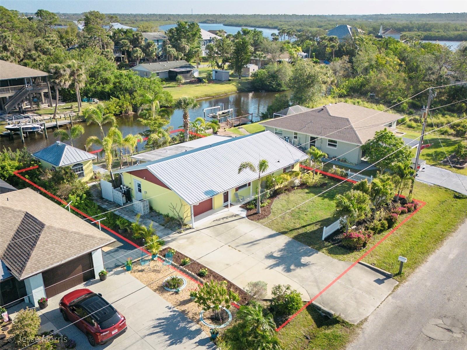 Waterfront Opportunity in a DREAM Location. Discover a remarkable two-bedroom, two-bathroom block home situated in the charming "Old Florida" style neighborhood of Tarpon Point. This tastefully updated residence is positioned along a canal, providing an exceptional opportunity to immerse yourself in nature and observe the rich diversity of Florida's wildlife. Enjoy your morning coffee on the back porch while watching an array of creatures, including manatees, dolphins, stingrays, and alligators. Launch your kayak directly from your backyard and paddle out to the Manatee River. Bask in the beautiful Florida sunsets right from your own backyard. This property is truly a haven for nature enthusiasts. The remodeled kitchen features ample cabinet space, granite countertops, and stainless-steel appliances. Recent updates include a new metal roof installed in 2023, repiping completed in 2019, and electrical enhancements. Adorable house shed used to be used as an office and could again. While the house sustained no hurricane damage, the dock was unfortunately lost and awaits your personal touch for reconstruction. Location is a dream: Minutes from Wellen Park, Restaurants and shopping including new Costco to the North, minutes from North Port to the South, Roughly 10 minutes to I-75 to the East and minutes to Englewood to the West. Myakka Nature Walking and biking trails 0.2 miles away.