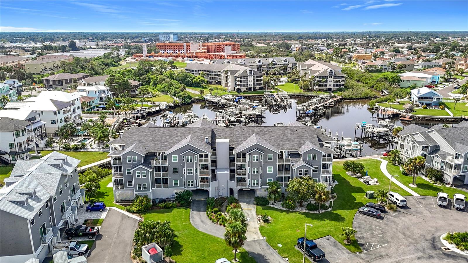 Incredible opportunity with spectacular views from this 3rd floor updated condo that includes a deeded boat slip with dedicated electric boat lift. This 2 bedroom, 2 bath home is surrounded by beautiful waters, abundant wildlife, and a vibrant community. Step into an open-concept layout designed with both entertaining and everyday tranquility in mind. The space flows effortlessly, allowing hosts to mingle during sunset cocktail hours or residents to savor a quiet morning coffee, all framed by breathtaking water views that serve as a living masterpiece. From virtually every vantage point within the residence, the Gulf stretches out before you. The kitchen boasts stunning granite countertops and a stylish backsplash that sets a sophisticated tone. With generous counter space, plentiful cabinets, and a pantry closet, culinary enthusiasts will feel right at home. The large primary bedroom is a true haven. Enjoy a super spacious walk-in closet, en suite bathroom, and a private balcony where you can greet the sunrise or unwind beneath the stars. The split layout ensures privacy from the guest bedroom, making this condo perfectly suited for snowbirds or full-time residents. Step out onto 1 of 2 balconies to soak in the panoramic water views. This vantage point is perfect for morning coffee, a good book, or an evening cocktail. Additional updates include Roof 2024, newer AC, Hurricane rated windows 2018, Hurricane rated sliding doors 2023, new laminate and new carpet in bedrooms 2023, siding 2023, new interior and exterior paint, auto dimmer lights in living room & kitchen, inside laundry room, alarm system, and a storage closet located adjacent to the elevator. Daily, you’ll be delighted by a parade of dolphins, enjoy watching a family of manatee that live in the cove, and a dazzling array of coastal birds: pelicans, herons, cranes, osprey, ibis, egrets. Community Amenities and Resort-Style Recreation include private covered parking and assigned space for ultimate convenience. Easy elevator access brings you directly to your condo—no stairs required. Community pool and clubhouse across the parking lot with a community heated pool for a refreshing dip or lounging beneath the sun, sauna, and jacuzzi located in Gulf Harbors main clubhouse. Membership in Gulf Landings Recreation Center and private beach club, offering countless amenities: Tennis and pickleball courts for friendly matches or active workouts. FLOOD INSURANCE INCLUDED IN CONDO FEES. Community boat ramp and assigned boat slip for easy access to the Gulf’s endless waterways, new dock planking, and new kayak launch dock, guest parking. Clubhouse with waterfront pool and spa for relaxation and social gatherings. Picnic areas with grills, plus a grilling station just steps from your condo. Extended dock for fishing, including a fish cleaning station for the day’s catch. Don’t miss this opportunity to create your own waterfront oasis in one of Florida’s most desirable boating communities! It is conveniently located to restaurants and (Publix) grocery store. Short drive to beautiful downtown New Port Richey…a historic Rivertown community with award-winning restaurants, shops, bars, and breweries. 6 miles to the Famous Tarpon Springs Sponge docks and only 22 miles to Tampa International Airport. Anclote Island and sandbar located 3 miles offshore.