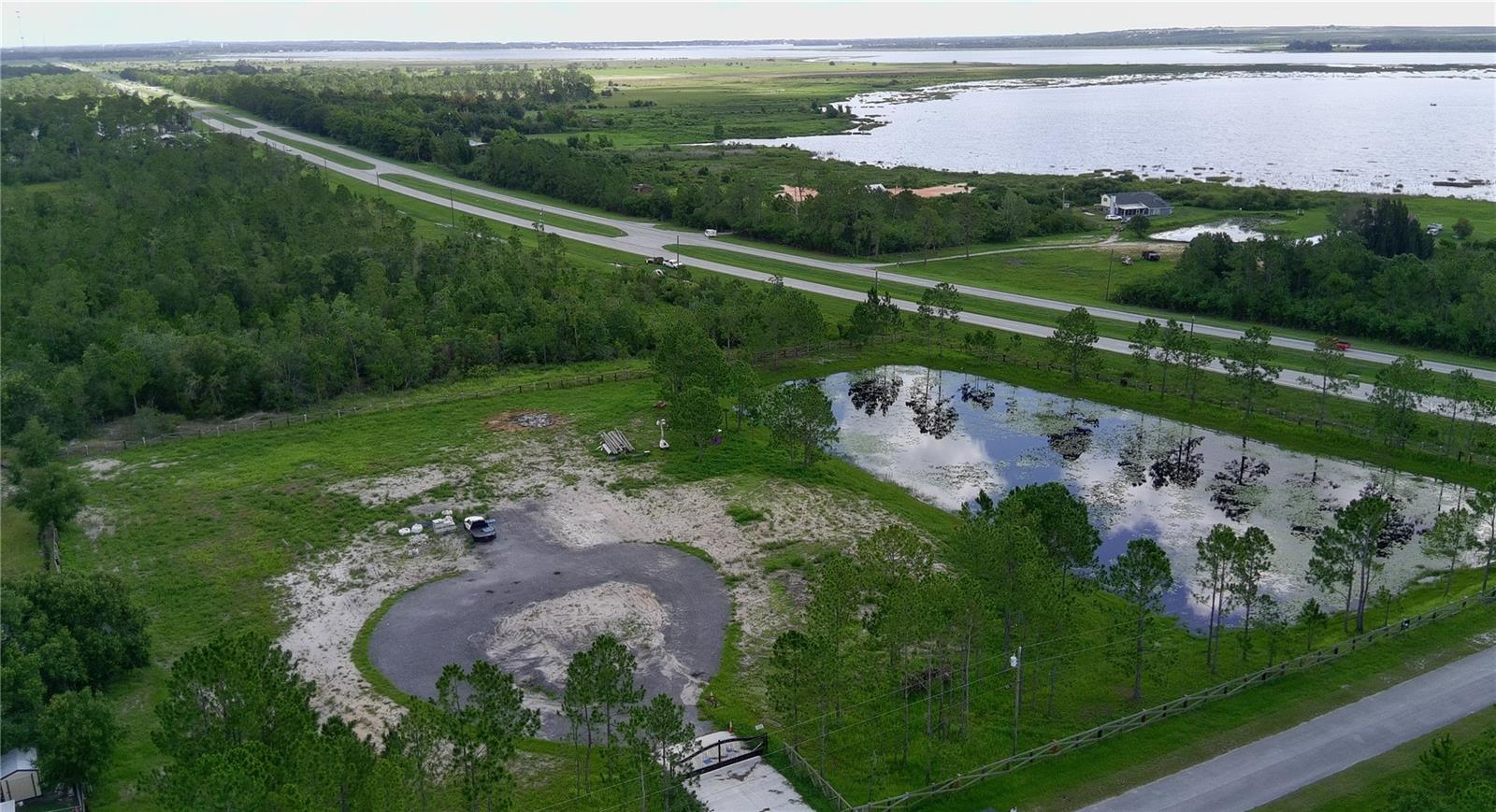 Check out this beautiful 4.7-acre parcel in Frostproof. Located just off of US 27, this fully fenced property offers the perfect blend of open space and natural beauty. A large, serene pond sits on the edge of the land—ideal for fishing, relaxing, or simply enjoying the peaceful view. Whether you're looking to build your dream home, create a private getaway, or start a small hobby farm, this property offers endless potential. The Property can also be subdivided or converted to c-3 Commercial to suit the buyer's needs.