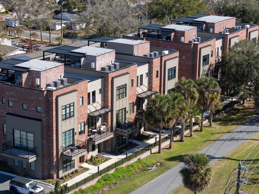 Welcome to 30 North Park, an exceptional townhome located in the heart of Historic Downtown Winter Garden — directly on the West Orange Trail and just steps from Plant Street Market, Crooked Can Brewery, local dining, shopping, and the weekly Farmer’s Market. This modern farmhouse-style residence offers four spacious bedrooms, each with a private en-suite bathroom and custom-fitted closets, providing comfort, privacy, and flexibility for guests, multigenerational living, or work-from-home needs. A first-floor bedroom serves as an ideal guest retreat, office, or flex space. The second level features an open-concept living area anchored by a designer kitchen complete with Bosch natural gas appliances, a large island, quartz countertops, farmhouse sink, artisan tile backsplash, and floor-to-ceiling windows showcasing views toward downtown and the West Orange Trail. A secondary bedroom with dramatic custom windows adds abundant natural light. On the third floor, dual primary suites offer spacious layouts, oversized windows, powered blinds, spa-inspired walk-in showers, and quartz-finished baths. Thoughtful upgrades throughout include warm wood flooring, patterned tile accents, modern black lighting fixtures, and extensive storage. Built with an STC soundproofing rating of 69, the home provides a quiet interior environment while remaining in one of Central Florida’s most vibrant walkable districts. Enjoy balcony views overlooking the trail and experience low-maintenance living with unmatched proximity to Historic Winter Garden’s amenities. Experience refined, walkable living in the heart of Winter Garden — schedule your private showing today.
