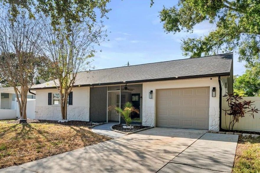 Welcome to your tranquil retreat in the heart of Northeast St. Pete's most convenient location! Set at the end of a quiet street, this fantastic pool home overlooks a peaceful nature preserve and sits on a generous lot with space for boat storage. The newly resurfaced swimming pool comes with a transferrable fifteen year warranty, new pump and anchors a fully fenced backyard enhanced with new maintenance free turf, mature landscaping, fireplace and a welcoming gazebo that creates an inviting outdoor retreat. Inside, the home showcases a thoughtful collection of upgrades. New luxury vinyl plank flooring pairs beautifully with fresh paint, stylish barn doors and eye-catching wood beams. The kitchen has been refreshed with all new stainless steel appliances, white shaker cabinetry, granite countertops, a spacious pantry and a dedicated coffee bar. The primary bedroom features an ensuite bathroom with a walk in shower framed by glass doors and river rock accents. Additional improvements include new light fixtures and ceiling fans, a newer roof, a new water heater, a brand new hurricane impact garage door, an ultra quiet garage door opener compatible with Google Home and Alexa, an electronic deadbolt, smart thermostat and an outdoor Wi-Fi camera system. Relax and take in the beauty of nature from your screen enclosed front porch. Situated just minutes from the Downtown St. Petersburg Waterfront and St. Pete Pier, this property provides convenient access to marinas, golf courses, premier dining, boutique shopping, and vibrant entertainment. Outdoor enthusiasts will appreciate proximity to local parks, recreation, and Weedon Island Preserve for pickleball, tennis, swimming and kayaking. Families will love the convenience of the nearby Shore Acres Elementary, Mangrove Bay Middle School and brand-new YMCA. Conveniently located to pristine Gulf beaches and international airports while still offering the privacy and tranquility of its preserve setting. A rare blend of location, upgrades and relaxed Florida living, listed under appraised value! Schedule your private tour today.