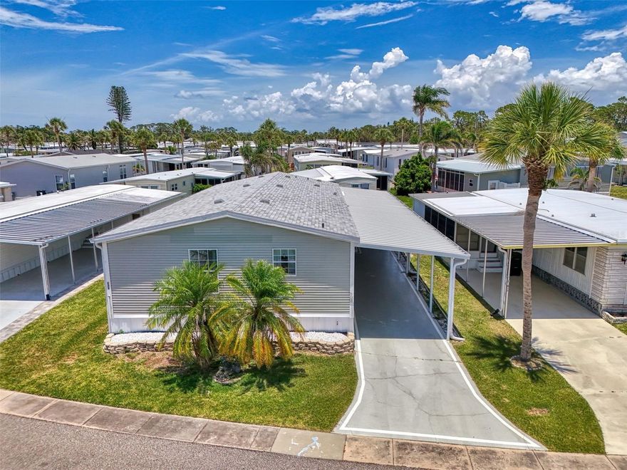 Step into relaxed Florida living just 1 mile from beautiful Manasota Beach! This cheerful 3-bedroom, 2-bath double wide mobile home is tucked inside the peaceful, amenity-packed community of Japanese Gardens—a highly desired 55+ neighborhood known for its fun lifestyle and great location. With low HOA fees and a long list of features, this home brings comfort, convenience, and coastal charm all in one. From the moment you arrive, you’ll notice the wide carport that easily fits up to three vehicles or two cars and a golf cart. Just off the driveway is a powered utility shed, ready for hobbies, storage, or tools. New Roof (2023) & New A/C (2024)! A covered side entrance leads into a cozy foyer and your own private laundry room—no more trips to the laundromat! Step inside to enjoy the popular open floor plan with stylish wood laminate flooring throughout the main areas and easy-to-clean tile in the kitchen and bathrooms. Over 1,600 sq.ft. of living space! The kitchen is a true standout with warm wood cabinets, solid surface countertops, a newer garbage disposal, and a large island that doubles as a breakfast bar for 6. It’s the kind of space where everyone loves to gather. The dining area opens directly into the living room, making it easy to host guests or just relax at the end of the day. The primary bedroom is tucked off the dining room and features an attached bathroom with dual vanities, a walk-in shower and generous cabinet space. And when it’s time to unwind, enjoy all the perks the community offers—swim in the heated pool, play pickleball or bocce, or join friends for fun events on the social calendar. Just minutes from shopping, restaurants, and top-rated medical care, this home has it all. If you're dreaming of easy living near the beach, this is the one. Call today for your private tour!