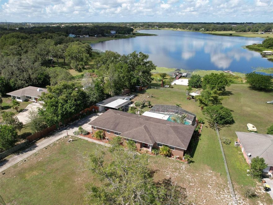 Charming LAKEFRONT home on over an acre of land in Central Florida! Enjoy the views of Lake Deeson from multiple spaces in this well loved home. This spacious home features 3 bedrooms and 3 full bathrooms, a large and refreshing pool, green house, multiple fruit trees, chicken coop, boat dock with seating area and your very own BEACH!!!! Entire property is fully fenced. It checks all the boxes! This is the perfect home to enjoy your privacy as well as entertain your guests at your leisure. Lounge by the pool or jump on the boat to enjoy some fishing and/or skiing! Plenty of room for parking and storage for all of your toys. Conveniently located to shopping as well as I4. Situated right between Tampa and Orlando, the best of both worlds! Your new home awaits you!