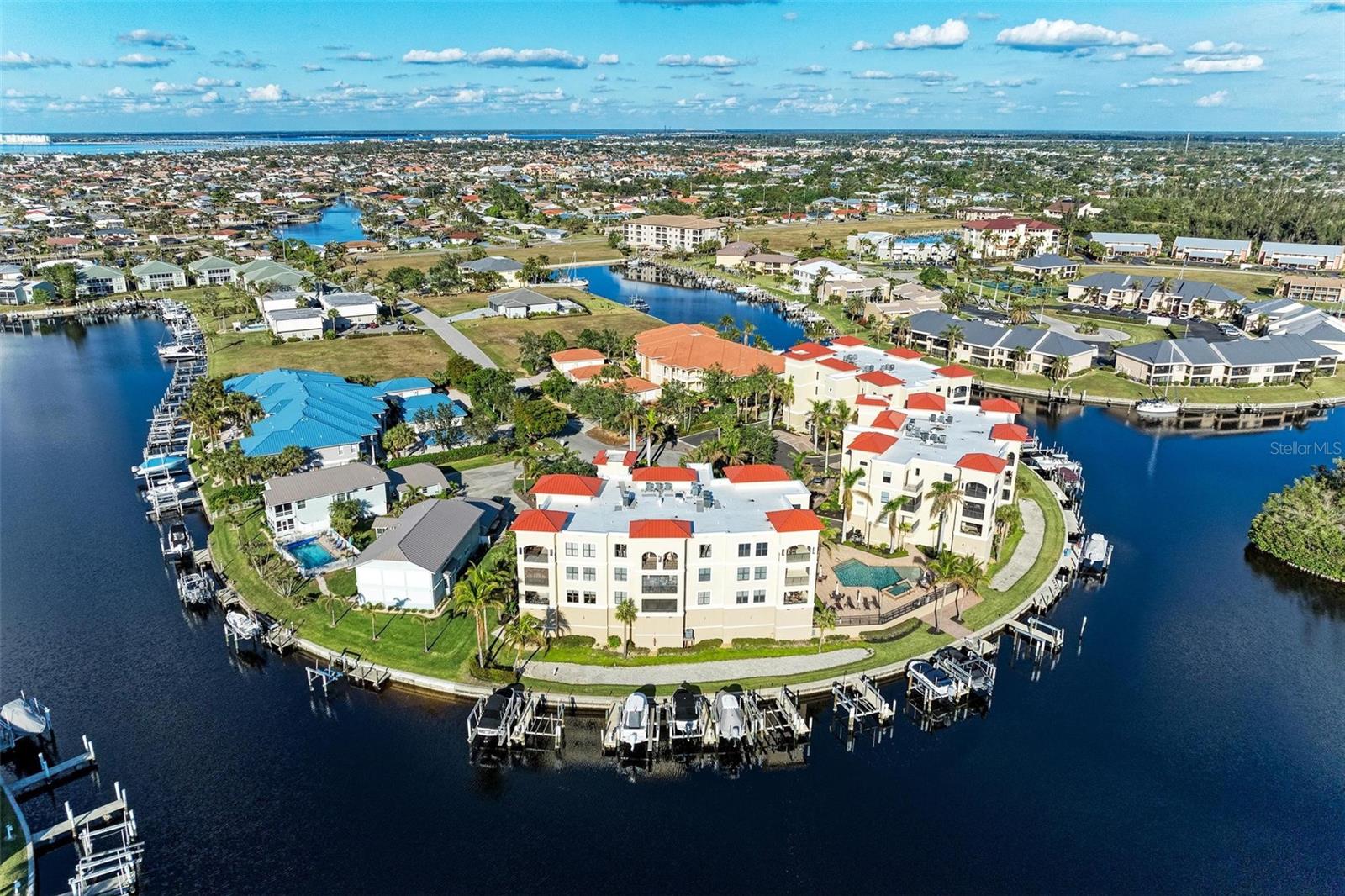 Gorgeous long water views will draw you into this luxurious and spacious 2 bedroom, 2 bathroom condo updated with new luxury vinyl plank flooring, a new kitchen with updated cabinets and quartz counters, a new A/C, new lighting and so much more! The resort style setting of Costa Bella Condos exhibits a beautiful lobby with secure entry to the building. COme up to the 2nd floor to find your new home with over 1800 square feet in this fantastic 2007 built condo that comes with all of the amenities you desire for Punta Gorda Isles living, including stunning waterfront, a deeded dock with a 10,000 lb boat lift, under building secure parking, a beautiful clubhouse, pool and spa area, and many more. Inside the unit you will find a spacious foyer diving the space to your large living room and great windows showcasing the rim canal views. From there, you will see the connected kitchen with quartz counter tops, a breakfast bar, and separate dining room. Enjoy from these spaces the beautiful lanai area positioned perfectly to see down 3 intersecting waterways. Both the master bedroom and bathroom are incredibly spacious, with spa-like quality, and the second bathroom and bedroom are perfect for accommodating any guests. The laundry room has additional storage in the condo, along with a fully air conditioned storage space in the garage area in front of your under building secure parking lot #7. Should you choose to invest, renting units here is a dream, with consistent demand due to the amenities available. Schedule your showing today.