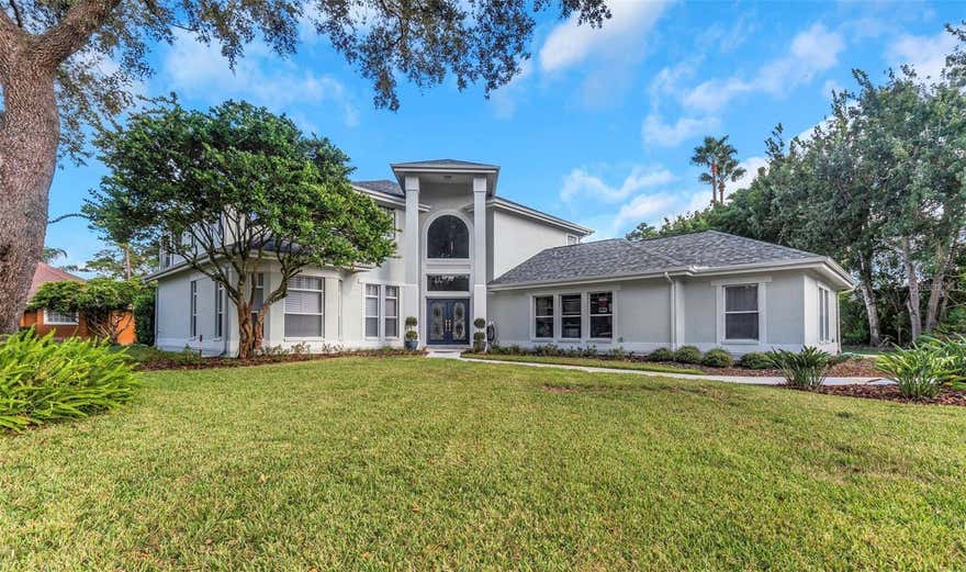 Welcome to the exclusive community of ARISTIDA,  offering tranquility, spacious lots, and custom homes.  NO FLOOD INSURANCE REQUIRED. Located on a Dead-End Street with no through traffic.  This custom built home is located on a .70 acres with generous foliage, fencing, and bamboo trees for privacy.  Majestic front entrance with soaring columns and double doors with etched glass.  The spacious kitchen, where meal prep will be a breeze with two new ovens, oversized island with built in cooktop, granite countertops, triple pantries, beautiful light  solid wood cabinetry, built in desk, beautiful hardwood flooring and triple collapsible sliders leading to the lanai.  All sliders are equipped with retractable shades.  The inviting Family room with gas fireplace, wet bar  with sink, custom built in cabinetry with a large TV, hardwood flooring & four additional sliders.  Just off the Family Room you will find a multi-purpose room, perfect for an home office, or additional bedroom. Also on the first floor is a guest bath, full pool bath with with a walk-in shower, mud room and a SPACIOUS Laundry room with washer, dryer, plenty of built in cabinetry for extra storage.  The upstairs primary suite features double door entry, huge walk-in closet, and an en-suite bath with gleaming porcelain tile flooring, expansive comfort height vanity with dual sinks and an oversized walk-in shower with frameless doors that also houses a beautiful soaking  tub .   Triple sliders lead from the bedroom to the balcony that runs the width of the home.  Three additional bedrooms and another full bath are on the second level.  Take a look at the unbelievably large BONUS  room, presently set up as a GYM. HAVE MULTIPLE VEHICLES, BOAT, ETC.? There are five attached garages that are out of view, an oversized two car garage (830 sq. ft.) and a separate 3 car garage.  There are three A/C systems, two water heaters, new carpet, newer pool heater and pump, pool recently resurfaced, ROOF 2025, and freshly painted interior and exterior.   Unwind in your pool and spa on your screened lanai with privacy hedge.  This custom home is perfect fit for the large family.  You will love what you see.