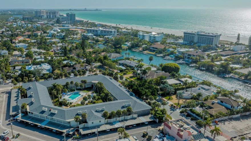 Enjoy the beach life in this thoughtfully UPDATED condo that boasts a coveted location directly behind St Armands Circle, just one block from Lido Key Beach, and over the Ringling causeway from downtown Sarasota and the Bayfront. The perfect year-round retreat, getaway for beach vacations, or potential rental investment, this 1-Bedroom, second-floor condo at Kingston Arms is ready to move in. As you enter the stylish condo, the open floor plan, gorgeous hickory vinyl plank flooring throughout and tropical-style fans in the living room and bedroom provide instant appeal. The tastefully remodeled kitchen has been completely opened up to the living room and features quartz counters, a stainless-steel apron sink, a large island with seating, and newer appliances. The king-sized bedroom boasts a roomy walk-in closet, its own mini-split A/C system. An additional mini-split A/C system cools the living area and there is a tankless water heater for convenience. The bathroom was beautifully remodeled and features new tile, quartz counter, and a lovely vanity. One covered parking space and a storage closet are included. When you are not using the condo yourself, Kingston Arms has a flexible rental policy, so you can let your guests experience the St. Armand’s lifestyle, while you enjoy the extra income. Whether you appreciate leisurely pursuits like shopping and dining on the Circle, strolling the sugar-white sands of Lido Beach, or you prefer to seek adventure-packed bicycling, kayaking, or paddleboard excursions, this ultimate location offers it all within walking distance, and is just around the corner from the free-trolley stop to downtown Sarasota, and all that it offers.