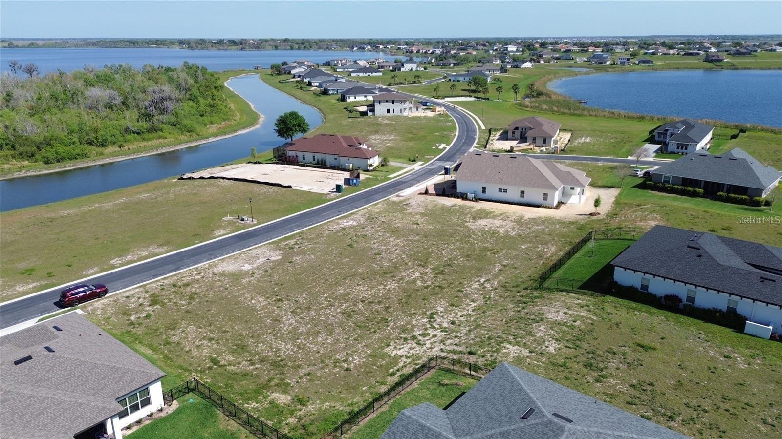Build your dream home in the beautiful gated community of Water Ridge. This beautiful 0.21-acre homesite offers the perfect setting with resort-style amenities, including three pools, a state-of-the-art fitness center, clubhouse, tennis courts, saunas, and private boat ramps with access to Lake Alfred and Lake Van. Enjoy the security of a 24-hour gated entrance, well-maintained grounds, and underground utilities. Conveniently located between Orlando and Tampa, with easy access to I-4, this community provides a balance of peaceful living and accessibility to shopping, dining, and entertainment. Don’t miss this opportunity to own in one of Central Florida’s premier neighborhoods.