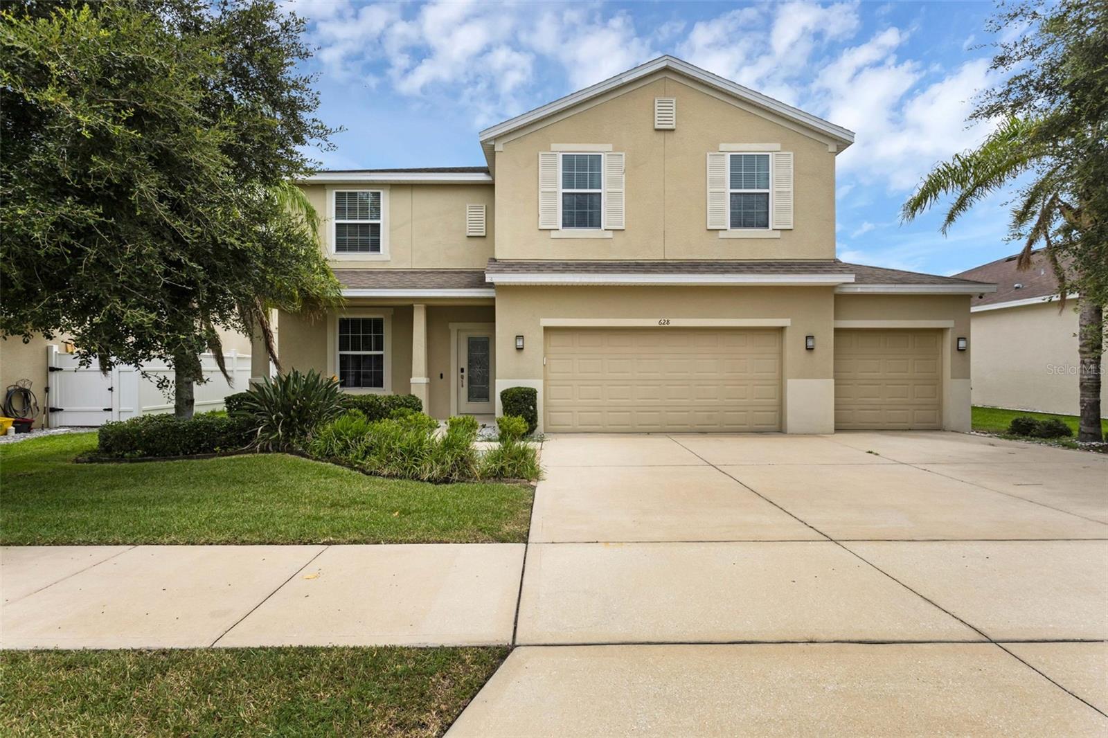 This spacious two-story home features a 3-car garage, a bonus loft, and a beautifully maintained exterior with a large fenced yard and no rear neighbors. The paver extension in the backyard adds a polished touch to the covered patio, offering a comfortable space for outdoor enjoyment. Inside, the kitchen is equipped with granite countertops and stainless steel appliances. The primary suite includes a double vanity, soaking tub, and separate shower. Additional highlights include a new AC unit and a backyard shed for extra storage. Located in a well-established community in Groveland, this home combines functionality with style and space for all your needs