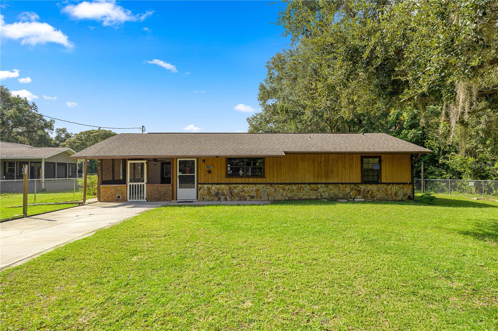 This charming 2 bedroom, 1.5 bath home is right around the corner from Lake Weir and ready for you to move right in! It is sitting on a fully fenced and gated oversized lot, perfect for pets, kids, or gardening. You can enjoy not one, but two screened in outdoor sitting areas and a large shed for all your tools and toys. The roof was replaced in 2019 and the drain field in 2020, so you can enjoy peace of mind knowing the major stuff has been taken care of. Whether you're looking for a cozy full time home, a laid back weekend getaway, or an investment
property this one has a lot to love!