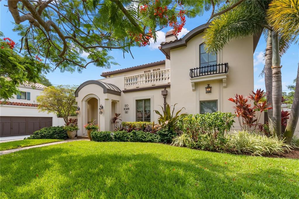 PREMIER LOCATION and beautifully updated with custom high end designer finishes! This stunning home is located just steps from Coffee Pot Bayou on the wide brick streets of Historic Granada Terrace in the Old Northeast Neighborhood. Royal Poincianas frame this Elegant Home with an artistic blend of Mid Century, Mediterranean and Modern Styles. A tropical vibe resonates from the Terrace overlooking Coffee Pot Bayou to the Grotto by the Pool. Admire the simple elegance, classic contemporary style and designer touches of this fully renovated home accented with Anderson impact windows, polished stone, walnut floors and many beautiful architectural details found throughout. The copper covered vestibule leads your guests into the warm and inviting living room with a gas fireplace. The dining room has sliding doors to the courtyard garden, bathing the space in morning light and salty breezes from the Bay. The gourmet kitchen offers a large island with seating, gas cooktop with warming drawer, double wall ovens with microwave and convection cooking, custom wood cabinetry with appliance storage, a walk-in pantry, a coffee station and ice maker. The family room features vaulted ceilings with wood beams, custom built-ins for media storage or display and sliders to the pool and lanai. Relax and unwind by the pool, watch a ballgame on the TV under the covered lanai and prepare your tailgate fare on the built-in barbecue. Retire to one of four bedrooms, all with ensuite baths. First floor suites overlook the pool or garden - each with private baths and custom closets. Make a grand exit up the stunning staircase to the double primary suite. The spa bath highlights a soaking tub that overlooks the Coffee Pot Bayou, a steam shower, large vanity and linen storage. The adjacent dressing room is a designer’s dream with custom closet, built-in storage and laundry chute to the first-floor laundry. The cozy bedchamber has warm beamed ceilings and a charming villa-style window box overlooking the pool. Separated by the landing and bar area with wine refrigerator, the fourth and final suite is ideal for an executive home office, media room or fitness room. It has access to the terrace and a full bath with shower and custom closets. Grab a nightcap and enjoy the gaslit fire while watching the sky change color over the Bayou. The layout of this home was carefully thought out with great entertaining and living spaces including a powder bath by the pool, laundry room with custom cabinets and lots of storage space. Bringing in groceries is a breeze from the attached two car garage with alley access. Walk or paddle along the waterfront, take your bike or golf cart to vibrant downtown shops, restaurants and museums or enjoy one of our major sporting and entertainment venues. Schedule a private showing and start living the Florida lifestyle.